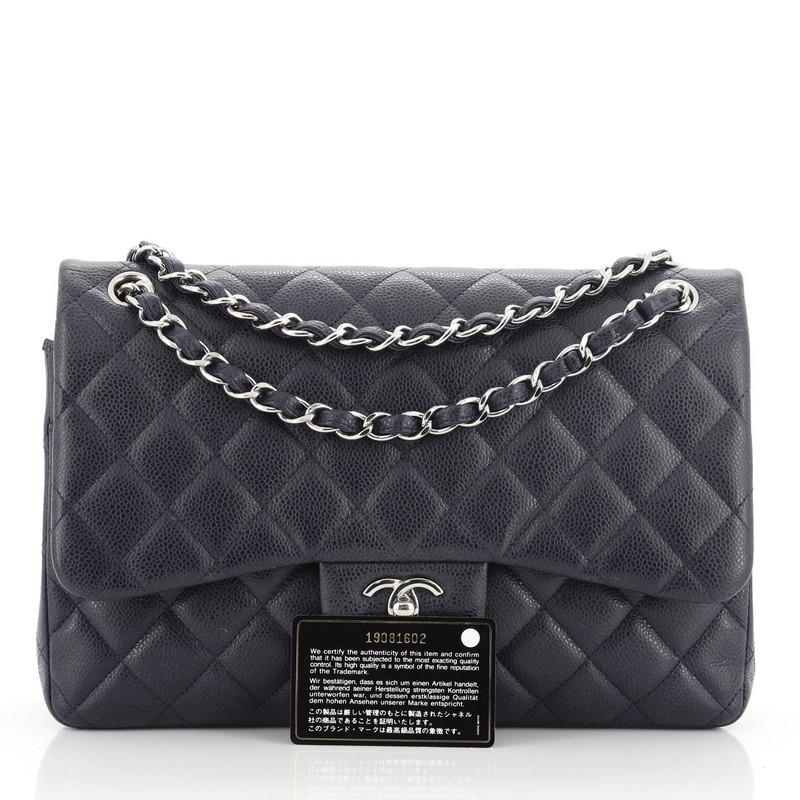 This Chanel Classic Double Flap Bag Quilted Caviar Jumbo, crafted from blue quilted caviar leather, features woven-in leather chain strap, exterior back pocket and silver-tone hardware. Its double flap and frontal CC turn-lock closure opens to a