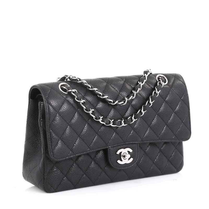 This Chanel Classic Double Flap Bag Quilted Caviar Medium, crafted from black quilted caviar leather, features woven-in leather chain strap, exterior back pocket and silver-tone hardware. Its double flap and frontal CC turn-lock closure opens to a