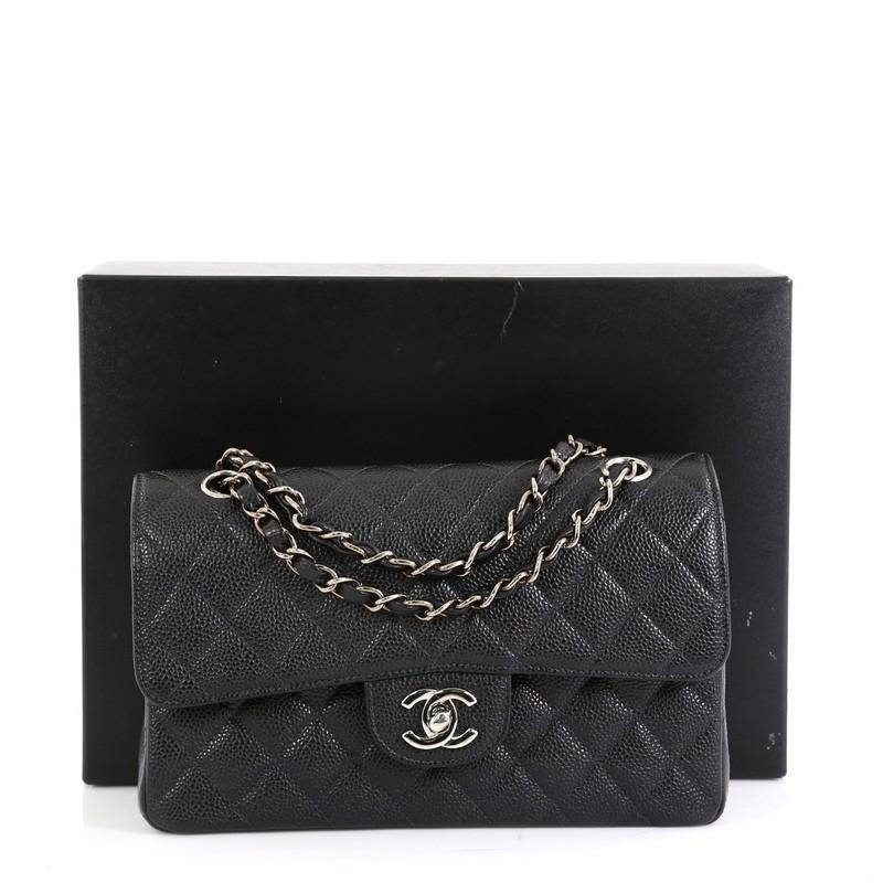 This Chanel Classic Double Flap Bag Quilted Caviar Small, crafted from black quilted caviar leather, features woven-in leather chain strap, exterior back pocket and silver-tone hardware. Its double flap and frontal CC turn-lock closure opens to a
