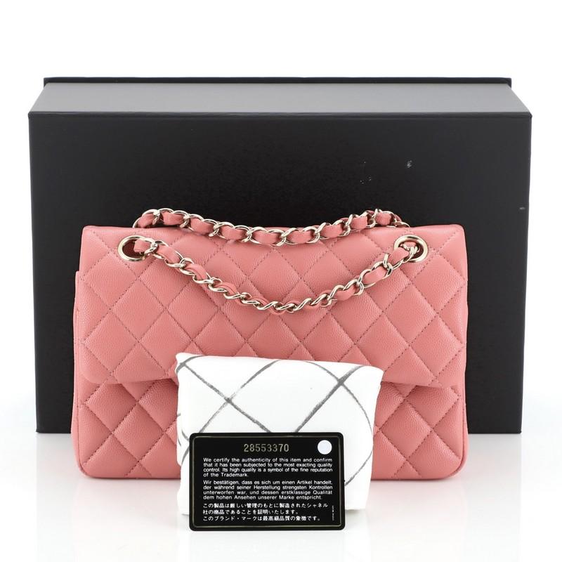 This Chanel Classic Double Flap Bag Quilted Caviar Small, crafted from pink quilted caviar leather, features woven-in leather chain strap, exterior back pocket and gold-tone hardware. Its double flap and frontal CC turn-lock closure opens to a pink