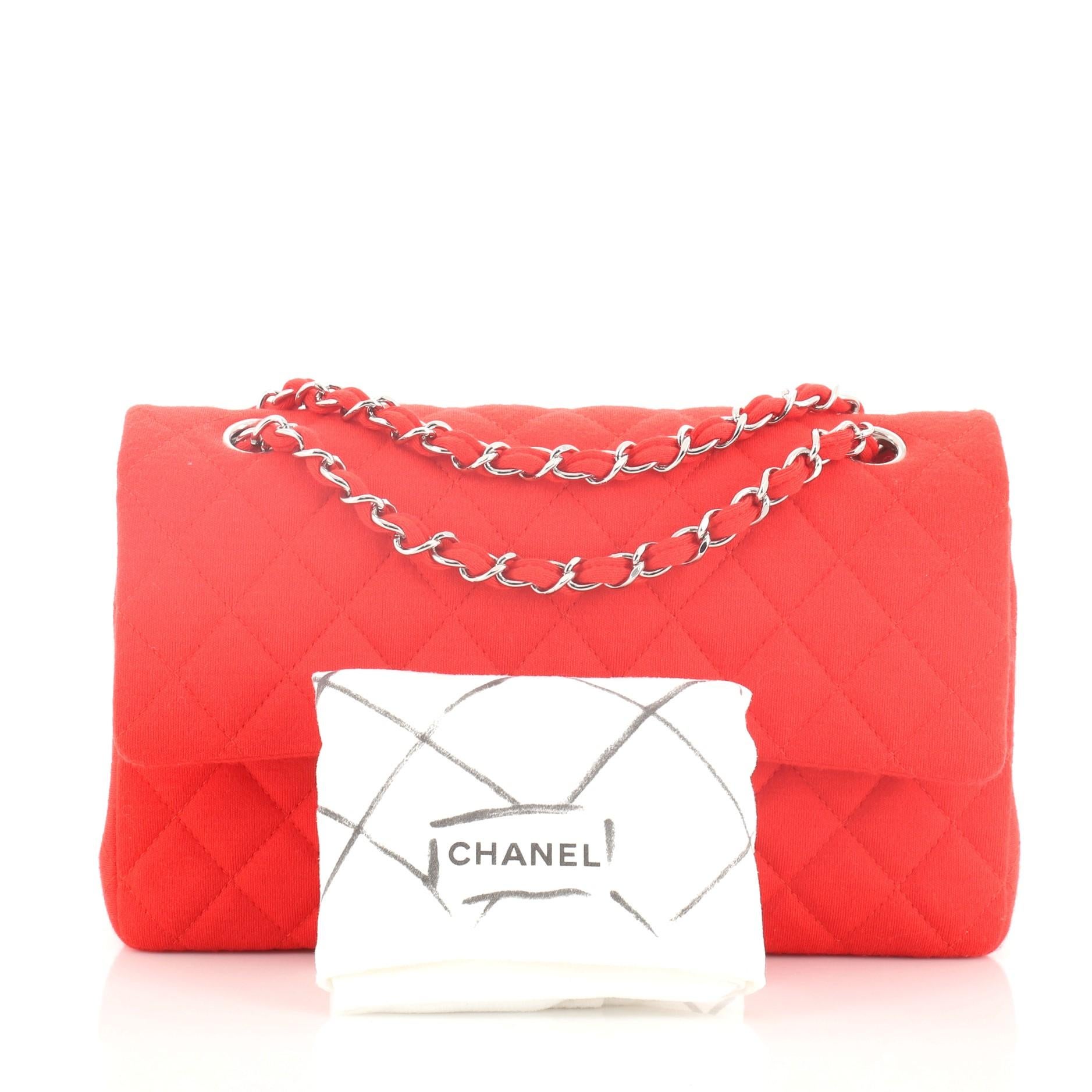 This Chanel Classic Double Flap Bag Quilted Jersey Medium, crafted from red quilted jersey, features woven-in jersey chain strap, exterior back pocket and silver-tone hardware. Its double flap and frontal CC turn-lock closure opens to a red leather