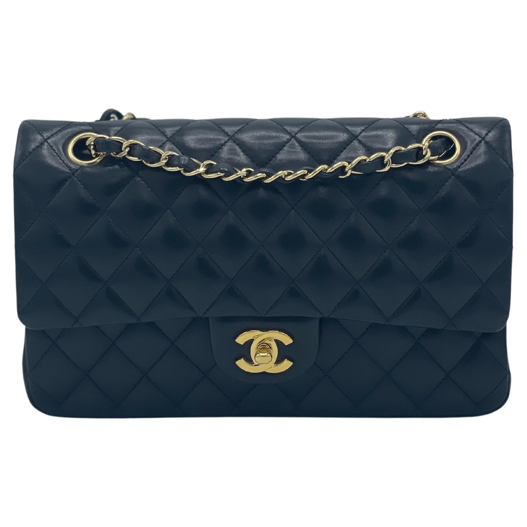 The famous Chanel Classic Double Flap new model shoulder bag is created in black diamond-quilted lambskin leather and adorned with gold-tone turnlock and chain hardware . 
The bag has a polished gold leather-threaded chain-link shoulder strap, a