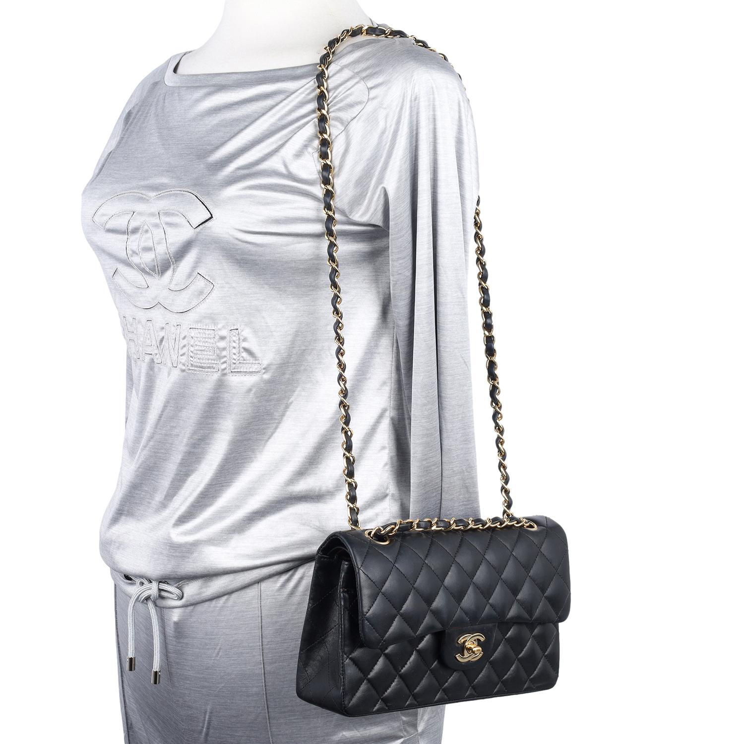 Authentic, pre-loved Chanel Classic double flap quilted lambskin leather shoulder bag in black. This classic shoulder bag is crafted of diamond quilted lambskin leather, features a rear pocket, gold chain-link shoulder strap threaded with leather