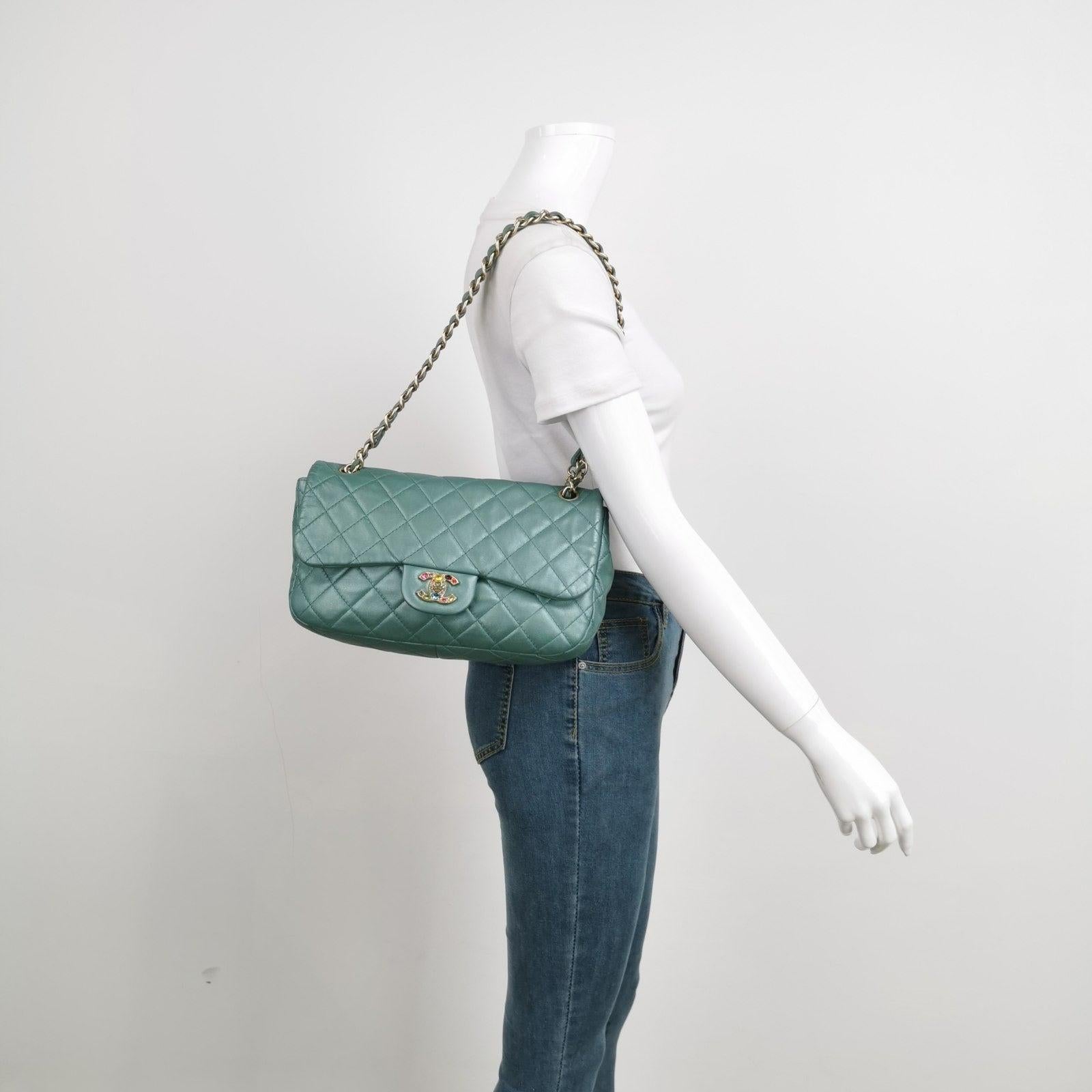 Chanel Classic Flap 2011 Large Teal Green Gem CC Turn lock These are professional photos of the actual bag offered by Luxbags. Chanel Timeless / Classic Flap in gorgeous teal green lambskin leather with gold-tone hardware. This rare find is adorned
