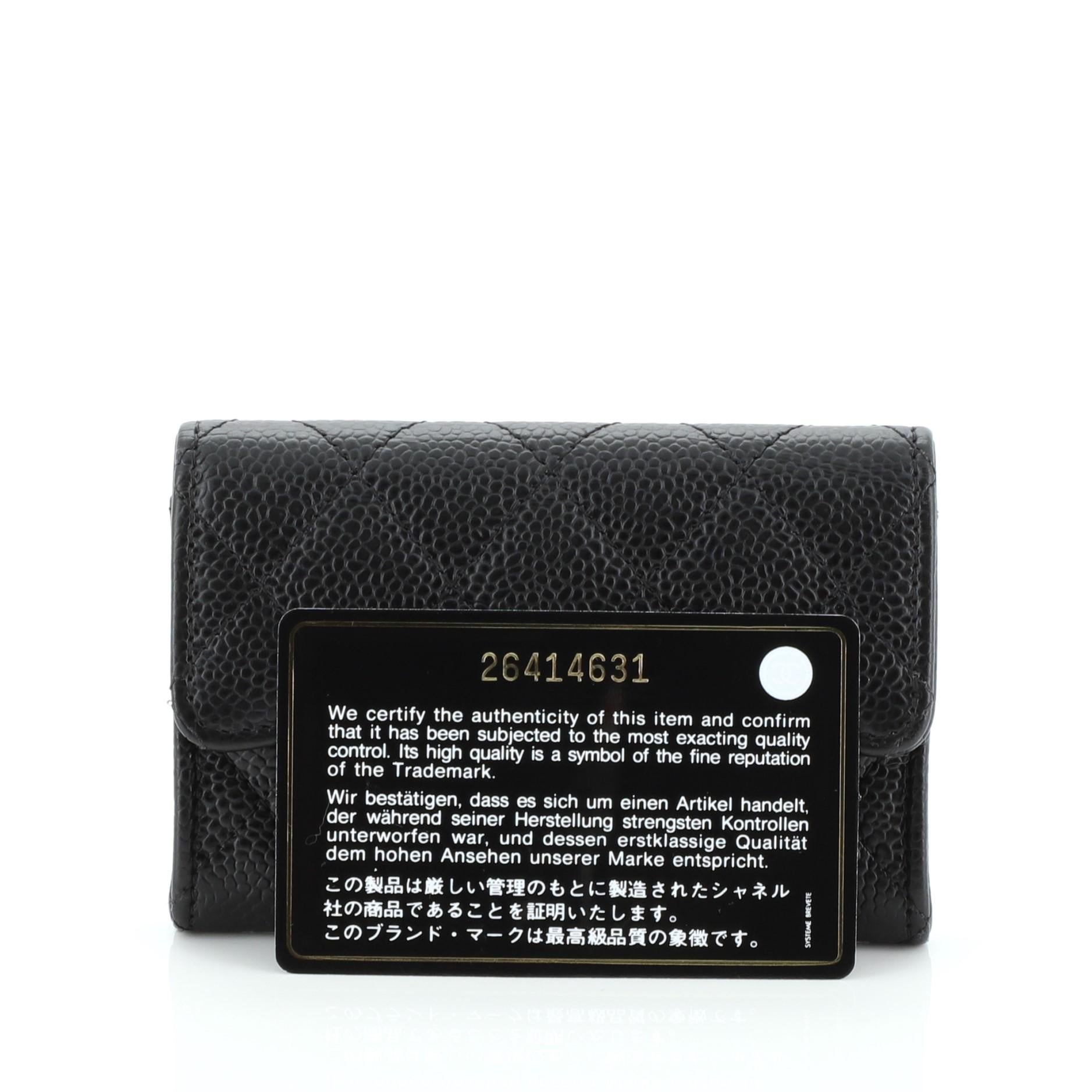 This Chanel Classic Flap Card Holder Quilted Caviar, crafted from black quilted caviar leather, features CC logo and silver-tone hardware. It opens to a black and red fabric interior. Hologram sticker reads: 26414631.

Condition: Excellent.