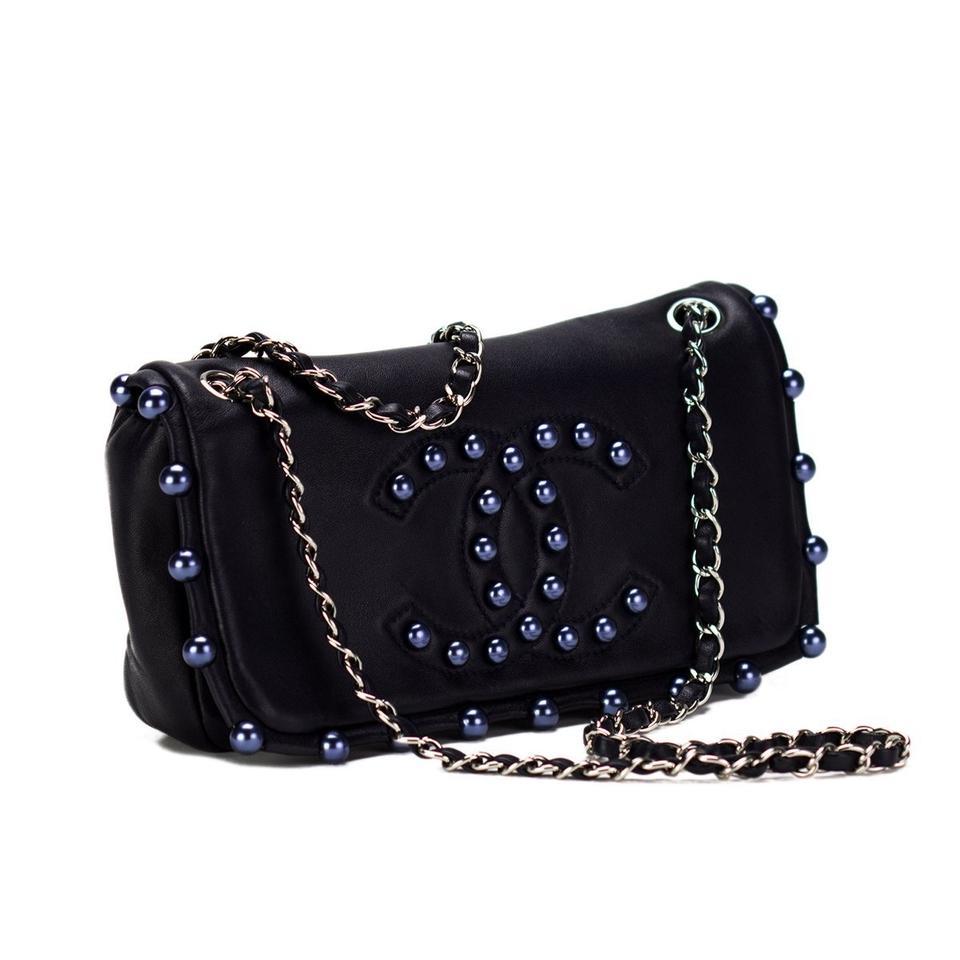 Chanel Classic Flap CC Obsession Rare Black with Dark Blue Pearls Lambskin Bag

Year: 2008  {VINTAGE 16 Years}
Silver hardware
Classic interwoven chain
Classic center zippered pocket
Flap lined with pearls
Grey satin interior lining
Strap Drop: