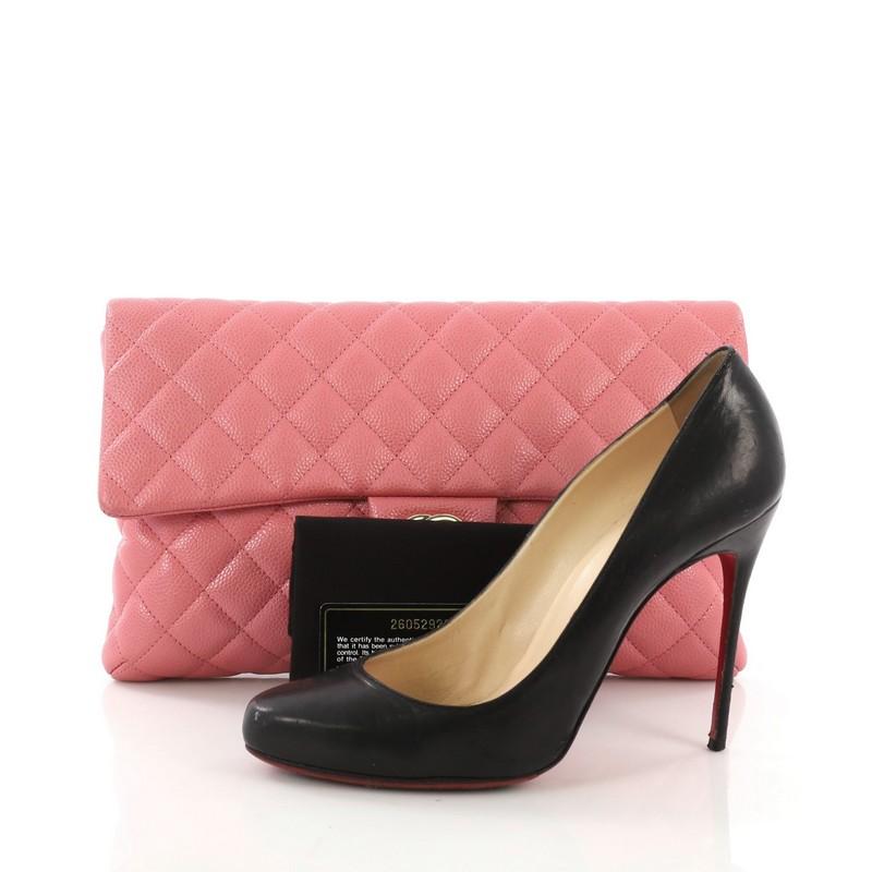This Chanel Classic Flap Clutch Quilted Caviar, crafted from pink quilted caviar, features frontal flap and gold-tone hardware. Its CC turn-lock closure opens to a pink leather interior with side zip pocket. Hologram sticker reads: 26052929. **Note: