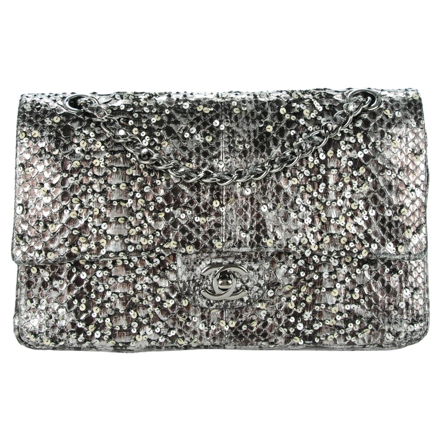 Charcoal grey Chanel python skin classic flap with sequin and beads.

Year: 2011
Silver hardware
Classic CC Closure
Interior flap zipper
Interior flap
Interior open pockets
Engraved interior CHANEL plaque
10