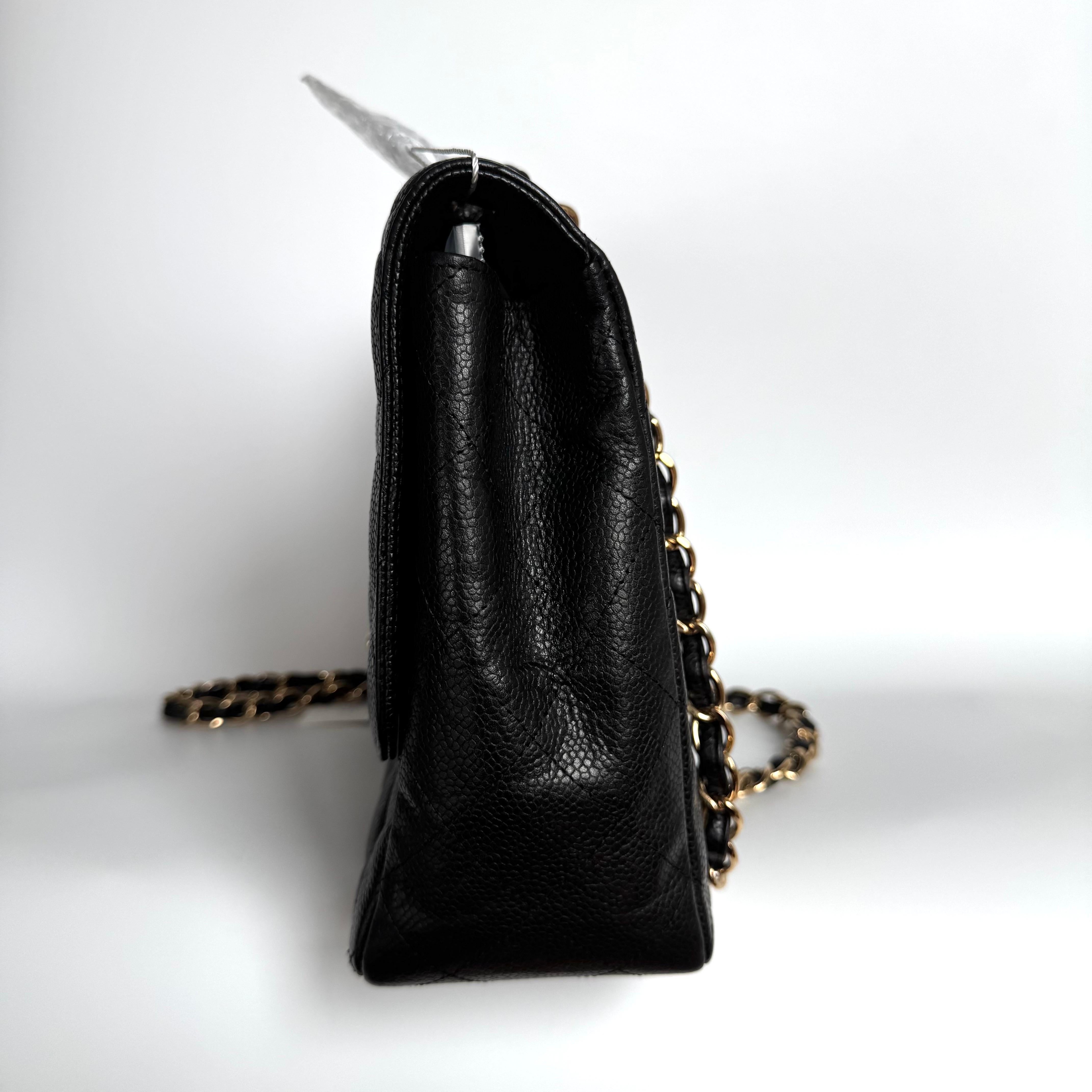 Embrace luxury with this timeless Chanel Classic Jumbo/Large Flap bag crafted in a scratch-resistant Caviar black leather and finished with gleaming gold hardware. 


CONDITION: VERY GOOD 

Light creases on the bottom. The bag has lost a bit of