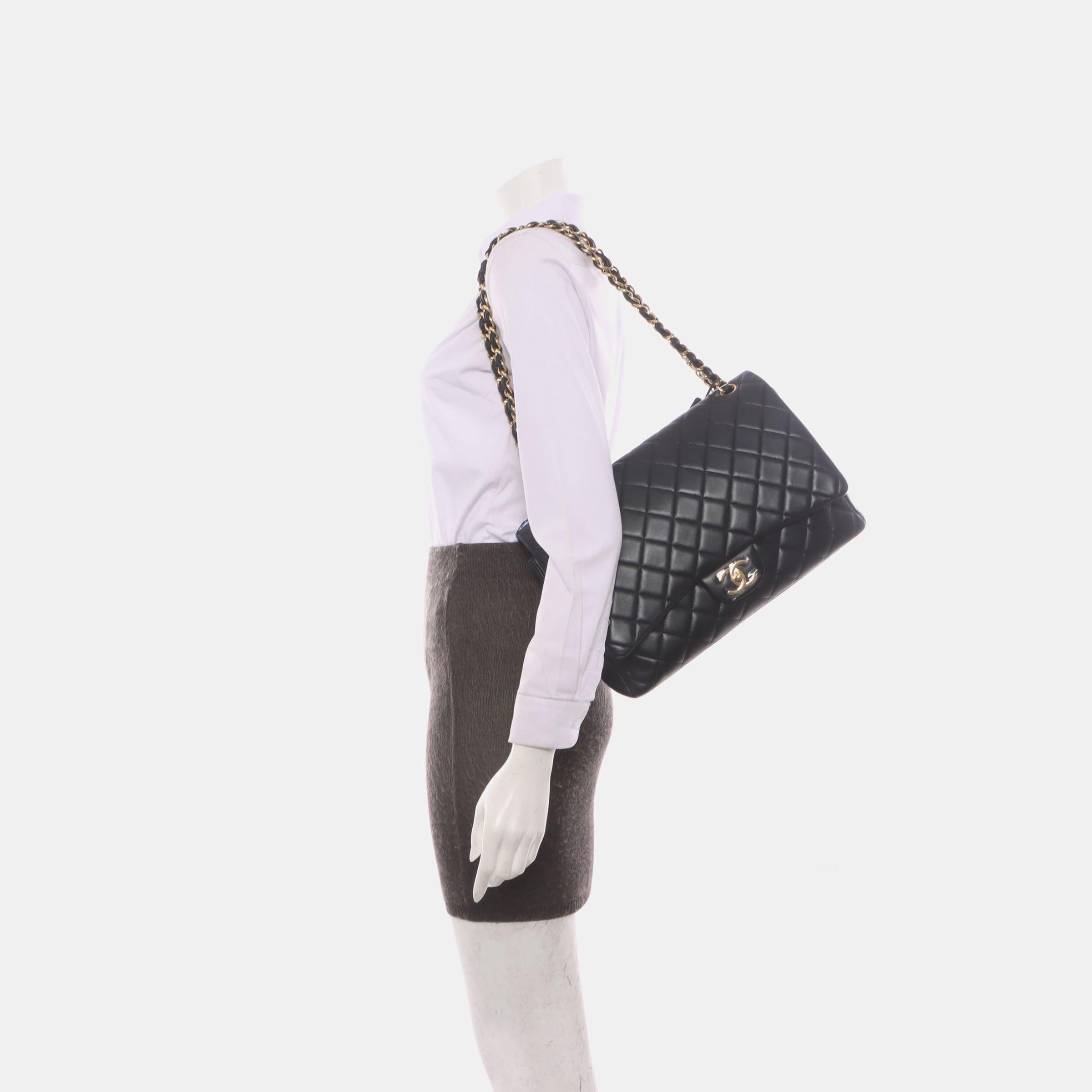 Chanel Classic Flap Maxi Black Lambskin Leather Double Flap with Gold Hardware, 2014-2015
 These are professional photos of the actual bag.
 CONDITION: VERY GOOD 
 Light creases near the bottom and on the back near the top. Rubbing on the corners,