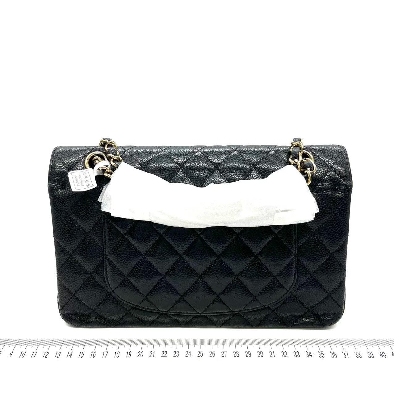 Chanel Classic Flap Medium Black Caviar Leather with 24k Gold Hardware, 2008-2009

  This one-of-a-kind Chanel Classic Flap Vintage bag exudes sophistication and timeless elegance. Crafted from black caviar leather, it is adorned with 24k gold