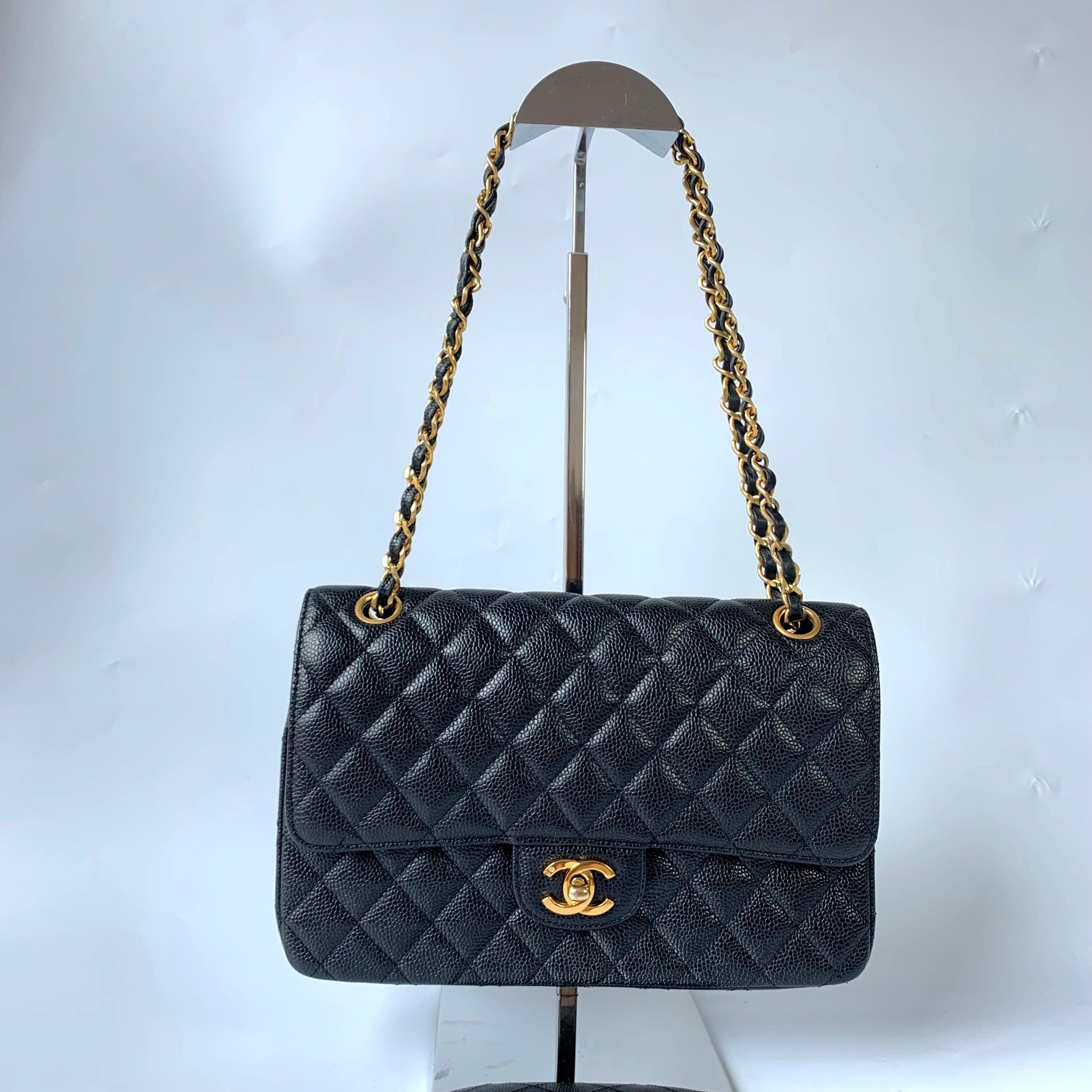 Chanel Classic Flap Medium Black Caviar Leather with 24k Gold Hardware, Pre-2010
These are professional photos of the actual bag.
  This one-of-a-kind Chanel Classic Flap Vintage bag exudes sophistication and timeless elegance. Crafted from black