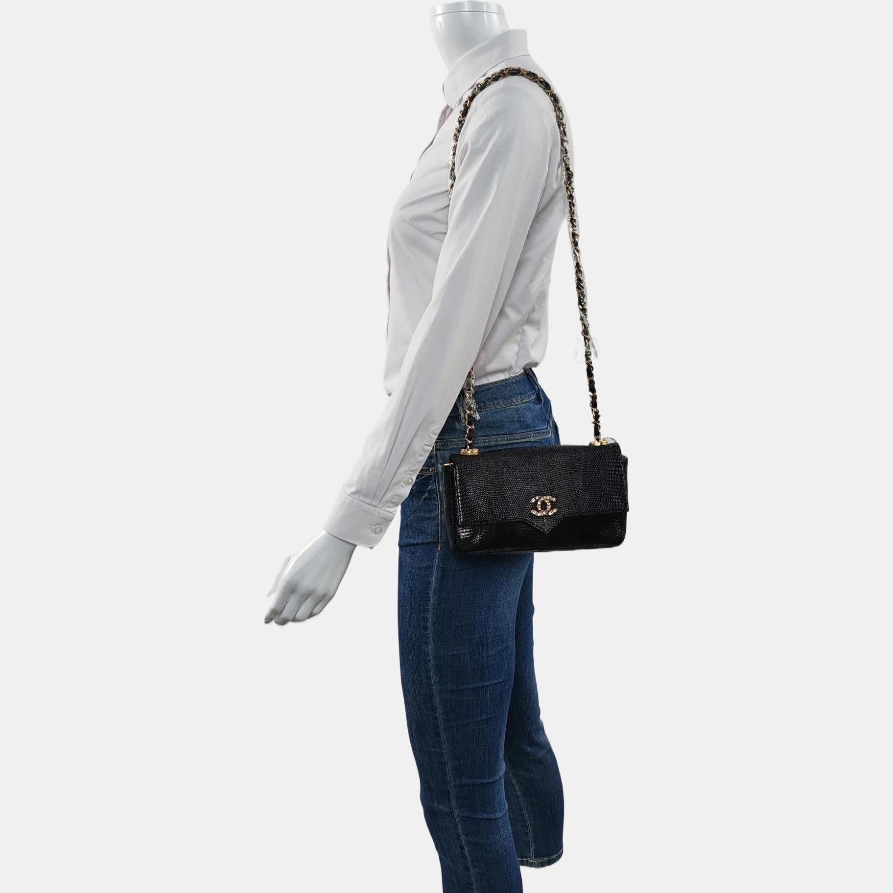 This one-of-a-kind Chanel Classic Flap Vintage bag exudes sophistication and timeless elegance. Crafted from luxurious black silk, it is adorned with gems studded CC buckle.  This bag is truly a piece of luxury worth cherishing. The long strap
