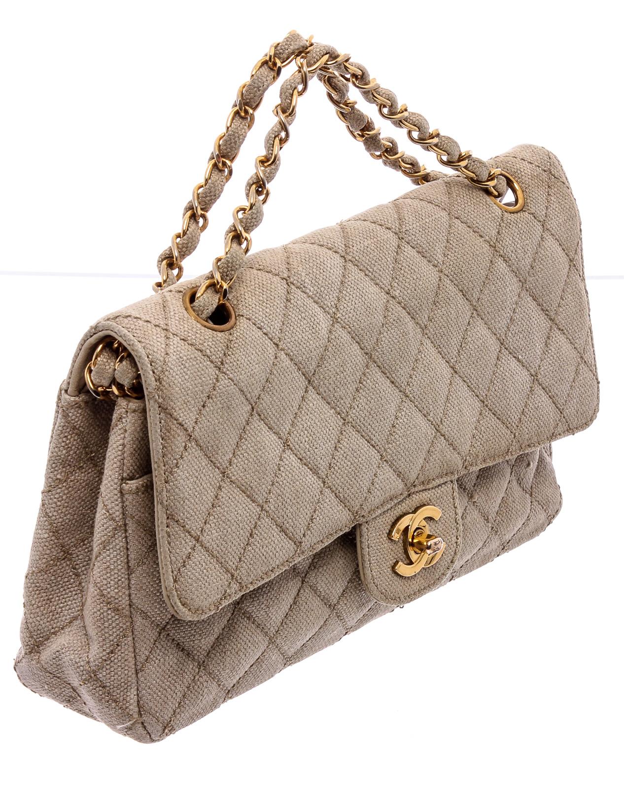 Beige quilted fabric Chanel Classic Medium Double Flap Bag with gold-tone hardware, patch pocket at back, dual chain-link and leather shoulder straps, pocket under flap with zip closure, beige leather interior, stitched CC logo under secondary flap,