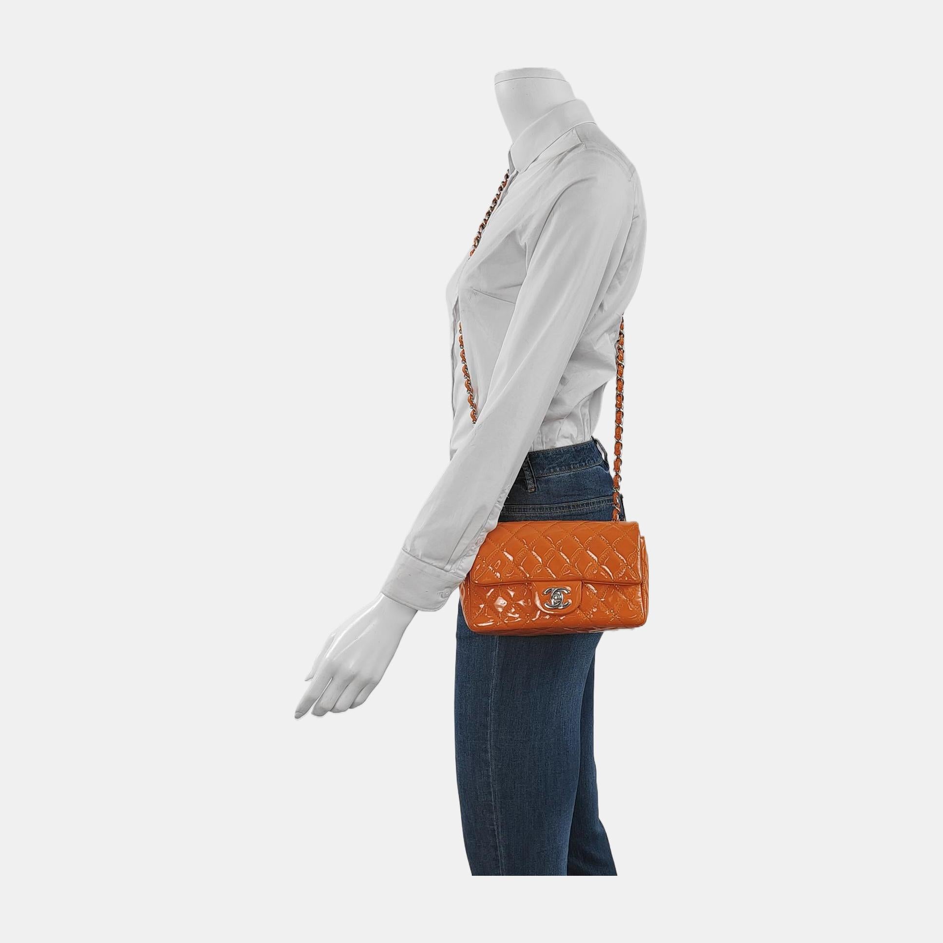 Add a touch of brightness to your summer wardrobe with this classic flap from Chanel, featuring a cheerful shine with its orange patent leather.

CONDITION: EXCELLENT

This previously owned and used item is in excellent condition with light signs of