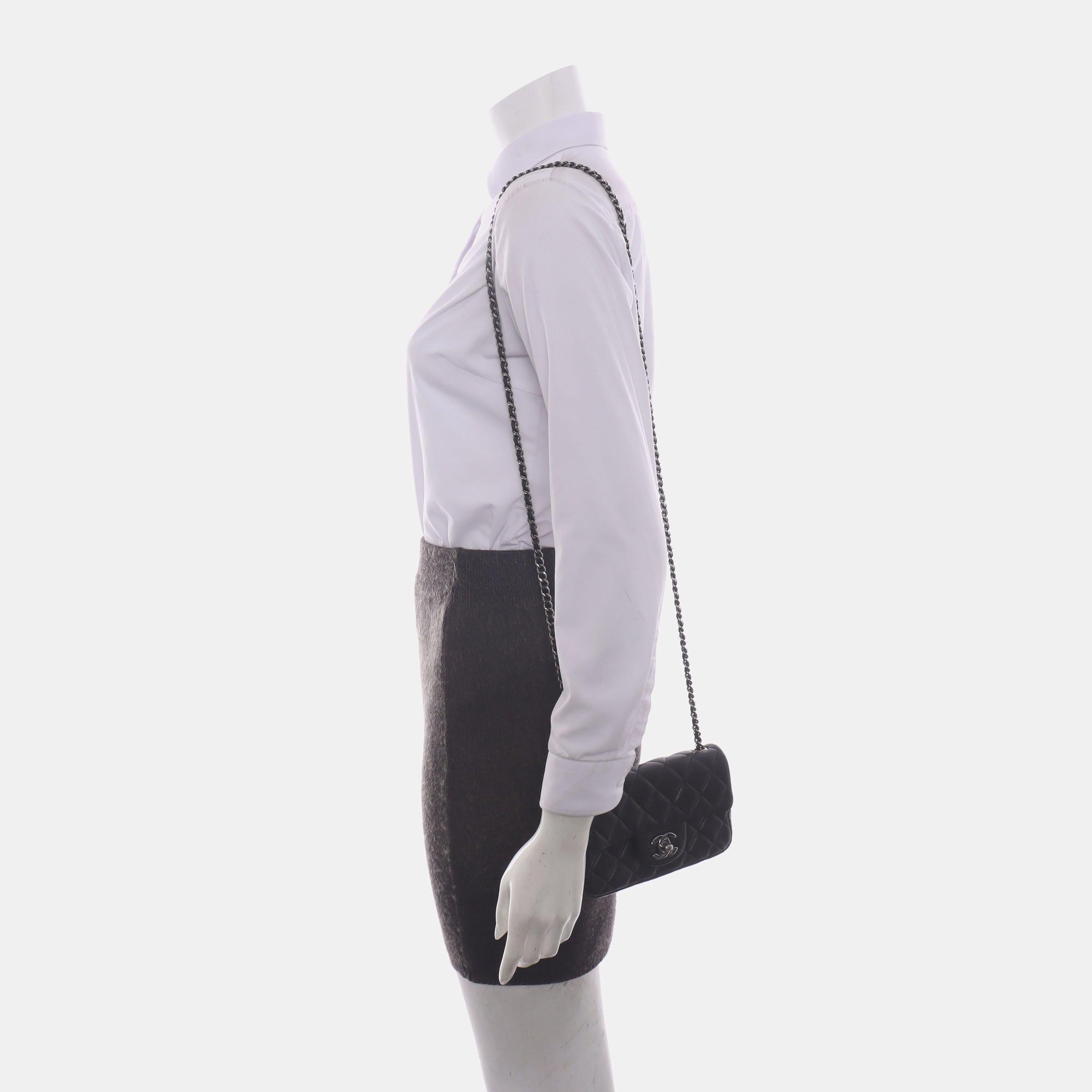 Chanel Classic Flap Super Mini Black Lambskin Leather Silver Hardware
 These are professional photos of the actual bag offered by Luxbags.
 Add a touch of brightness to your summer wardrobe with this classic flap from Chanel, featuring a cheerful
