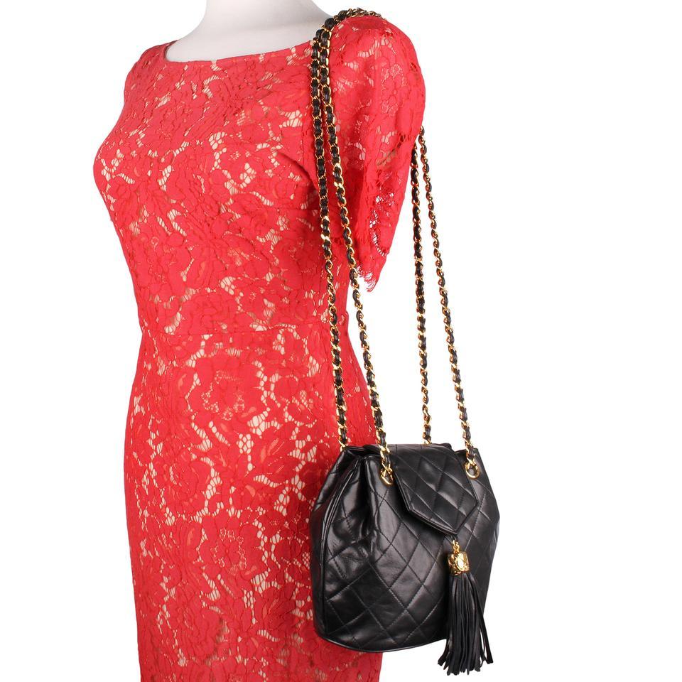 Authentic, pre-owned Chanel classic flap black crossbody bag. This very rare CHANEL front flap bag features quilting lambskin leather, stitched CC on the bottom, front flap snap closure. There is a flirty leather tassel with 24 kt gold plated CC cap