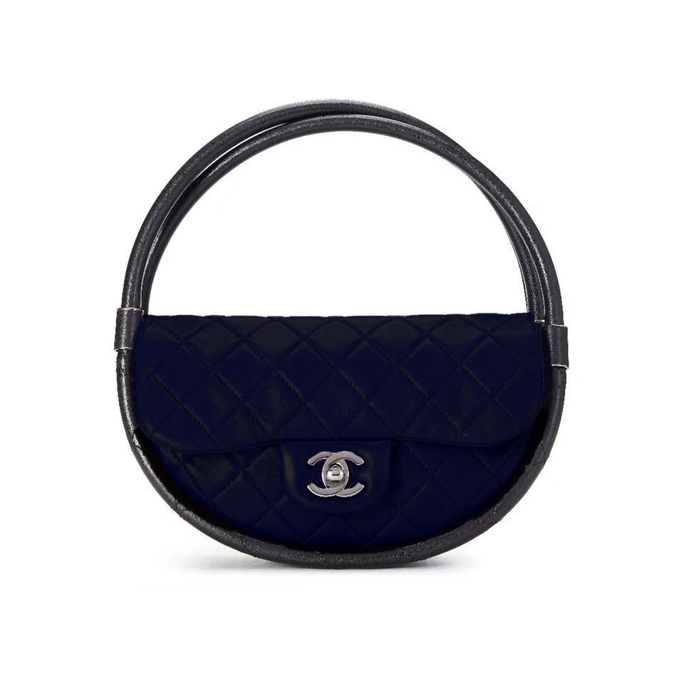 Chanel Limited Edition Mini Classic Flap Hula Hoop Clutch Tote Bag

Year: 2013
Silver hardware
Quilted Lambskin Leather
Classic CC Mademoiselle turn lock
Classic back pocket
Jacquard fabric interior lining
Circular double structured handles
5.5' H x