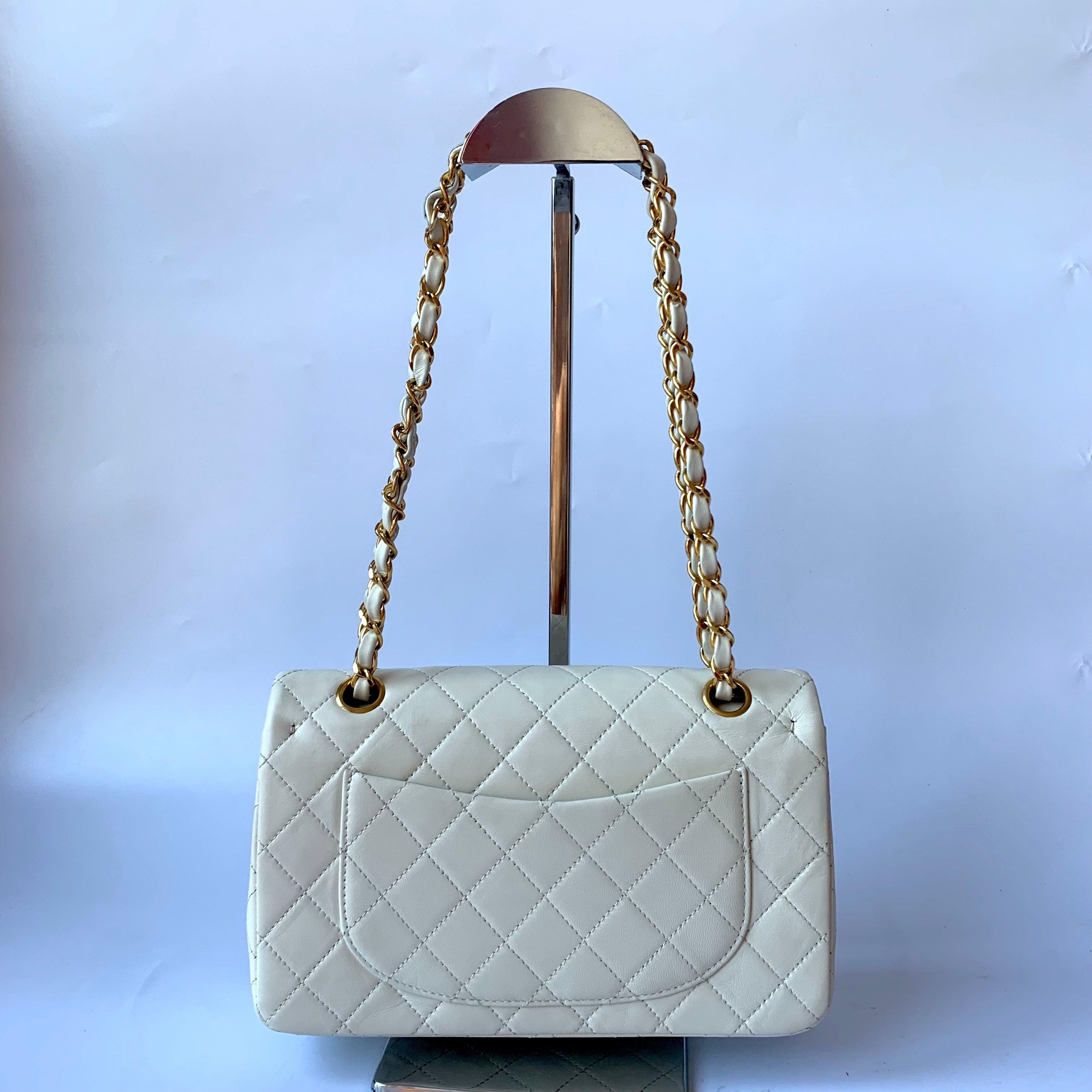Chanel Classic Flap Vintage 1995 White Lambskin Leather with 24k Gold Hardware
These are professional photos of the actual bag.
  This one-of-a-kind Chanel Classic Flap Vintage bag exudes sophistication and timeless elegance. Crafted from luxurious