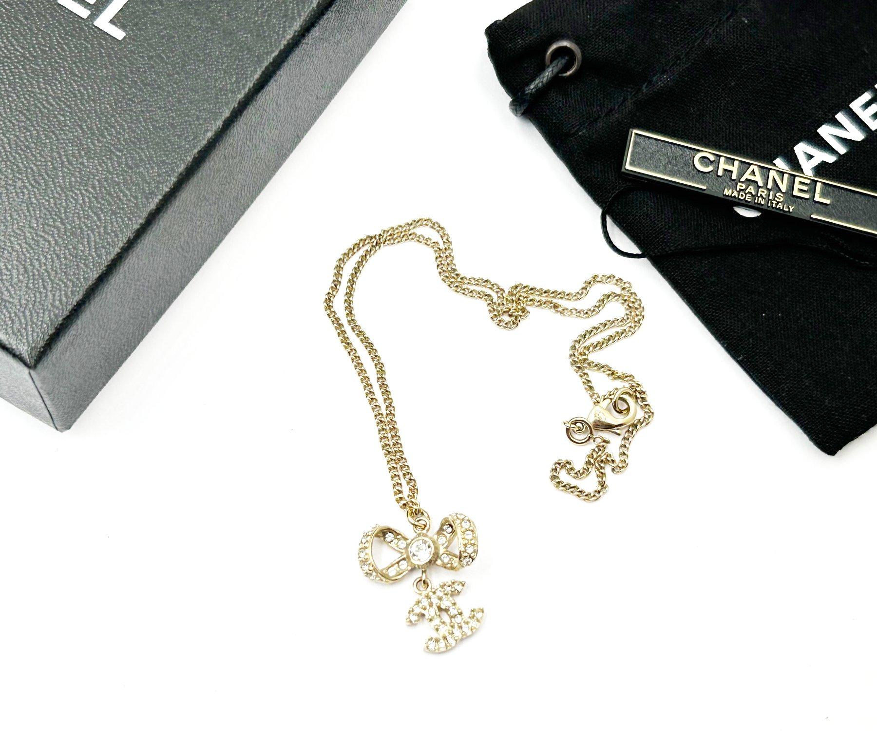 Artisan Chanel Classic Gold Ribbon Bow CC Crystal Pendant Necklace  For Sale