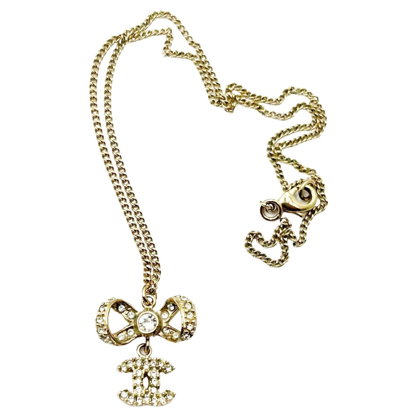 Chanel Classic Gold Ribbon Bow CC Crystal Pendant Necklace  For Sale
