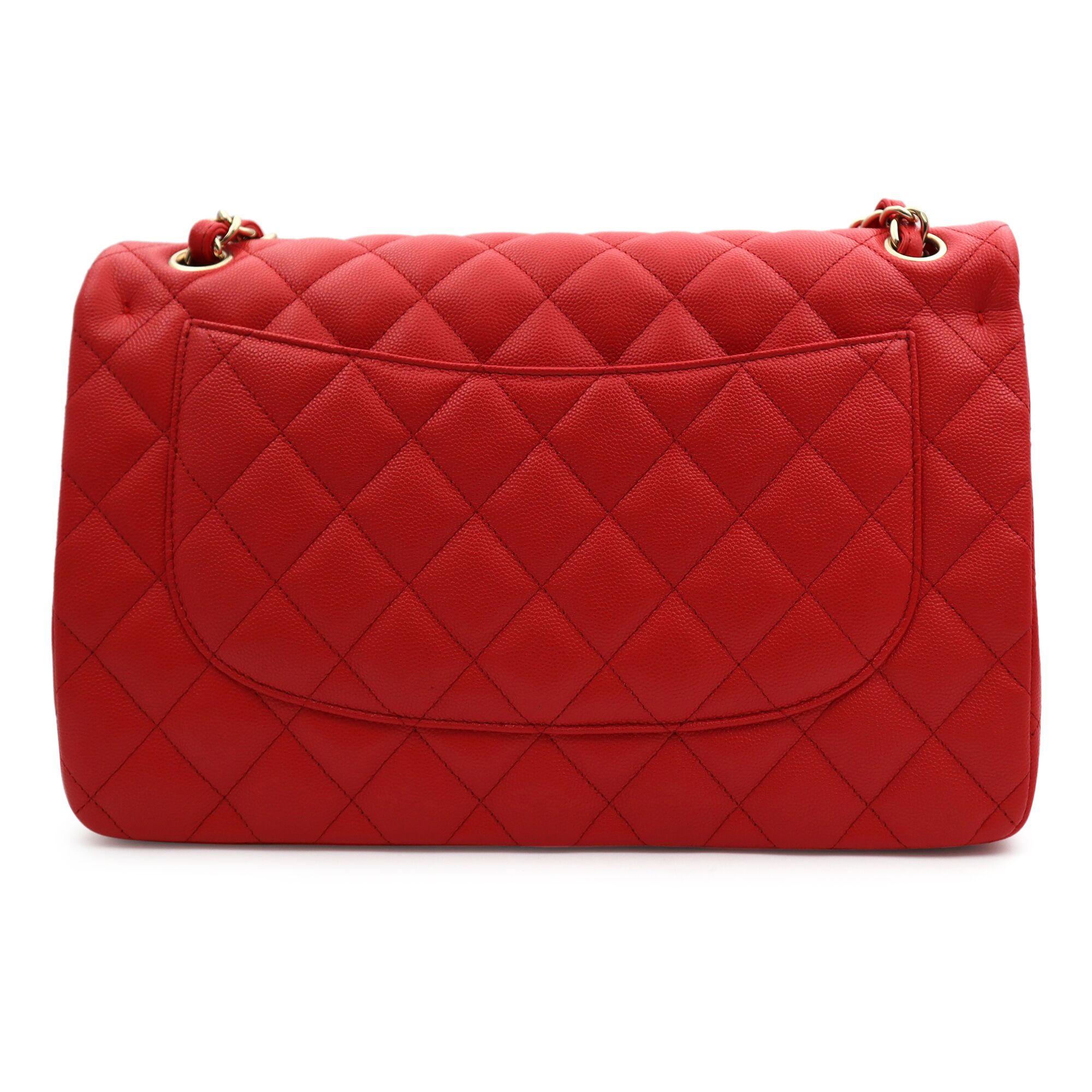 This chic Chanel classic large double flap bag is crafted of caviar leather in beautiful coral red color. The bag features a gold tone chain link leather threaded shoulder straps and a facing gold tone Chanel CC turn lock. The bag opens facing flap