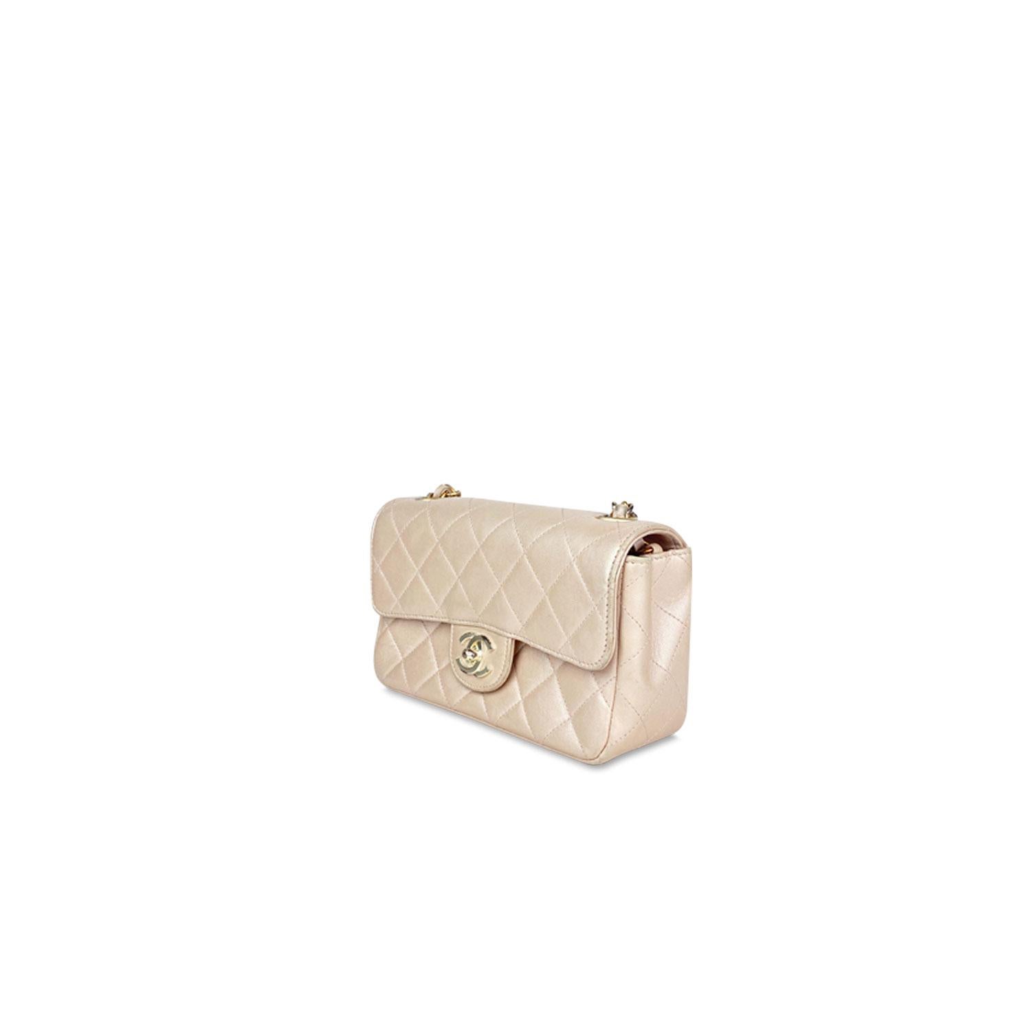 Nude quilted leather Chanel Classic Mini Rectangular flap bag with

- Gold-tone hardware
- Single chain-link and leather shoulder strap
- Pink leather interior
- Dual interior compartments, single interior card slot and magnetic-lock