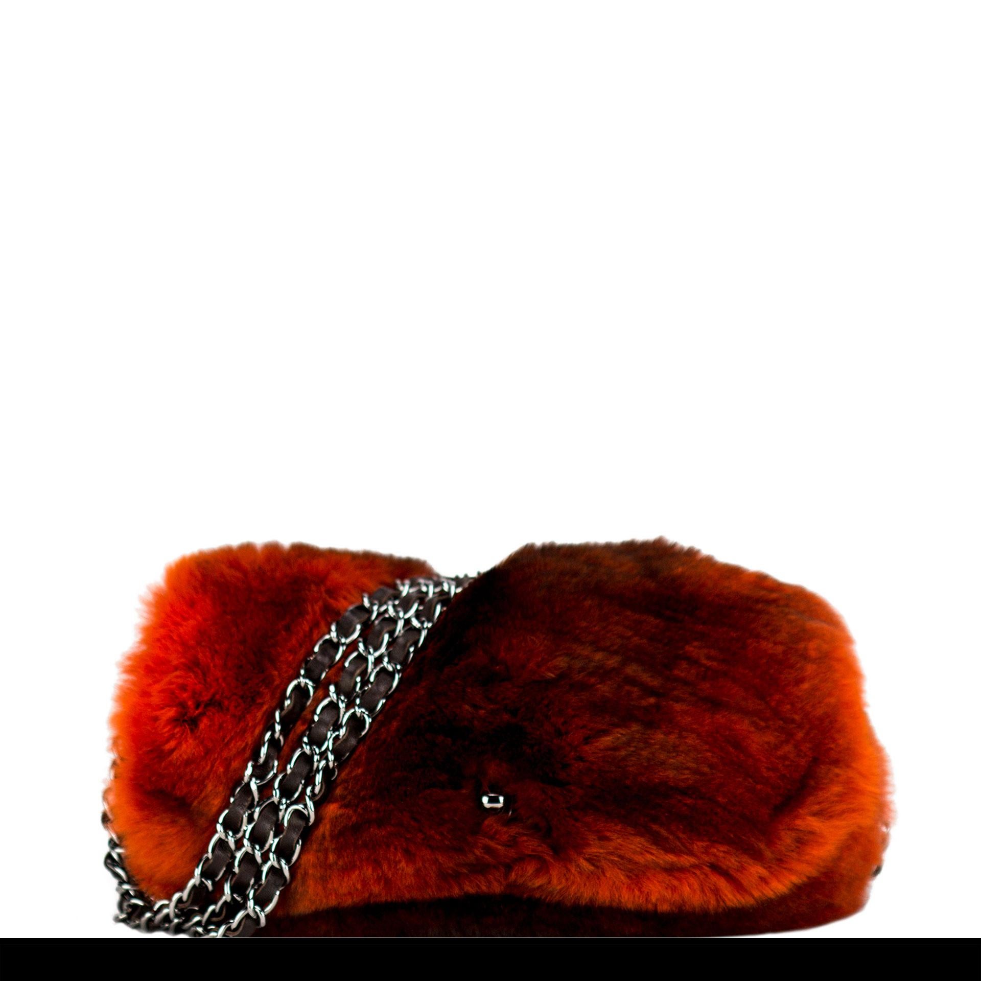 Chanel Ombre Chanel fur triple interwoven chain flap with classic cc Turnlock closure

Year: 2014
Silver hardware
Interior brown lambskin lining
Interior brown graffiti lining
Strap drop 10”
6” H x 10” W x 3” D

Made in France