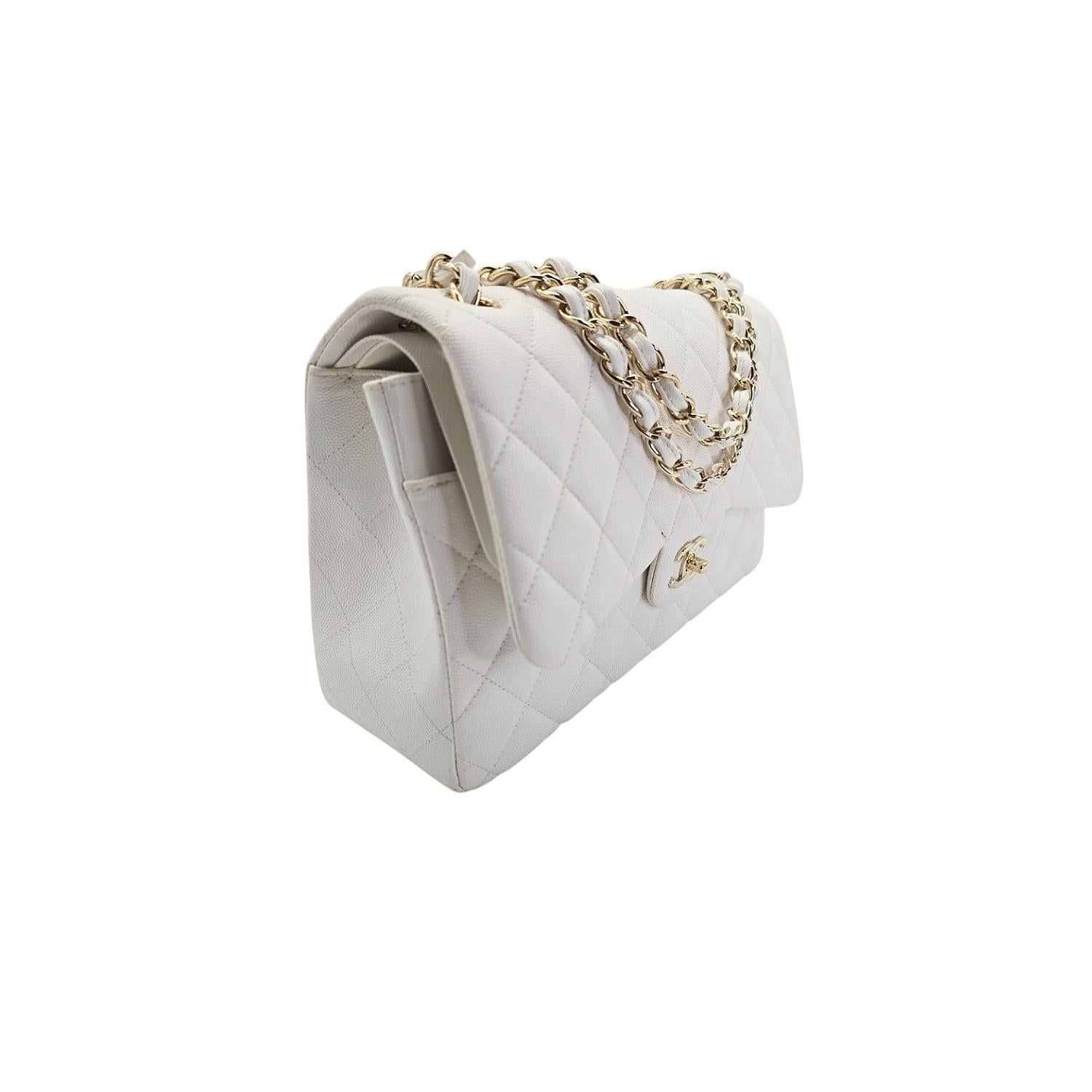 This Chanel Quilted Jumbo Double Flap is crafted of fine diamond-quilted white caviar leather. The bag features leather threaded gold chain shoulder straps, an interior flap, and a facing half flap with a light gold Chanel CC turn lock. This opens