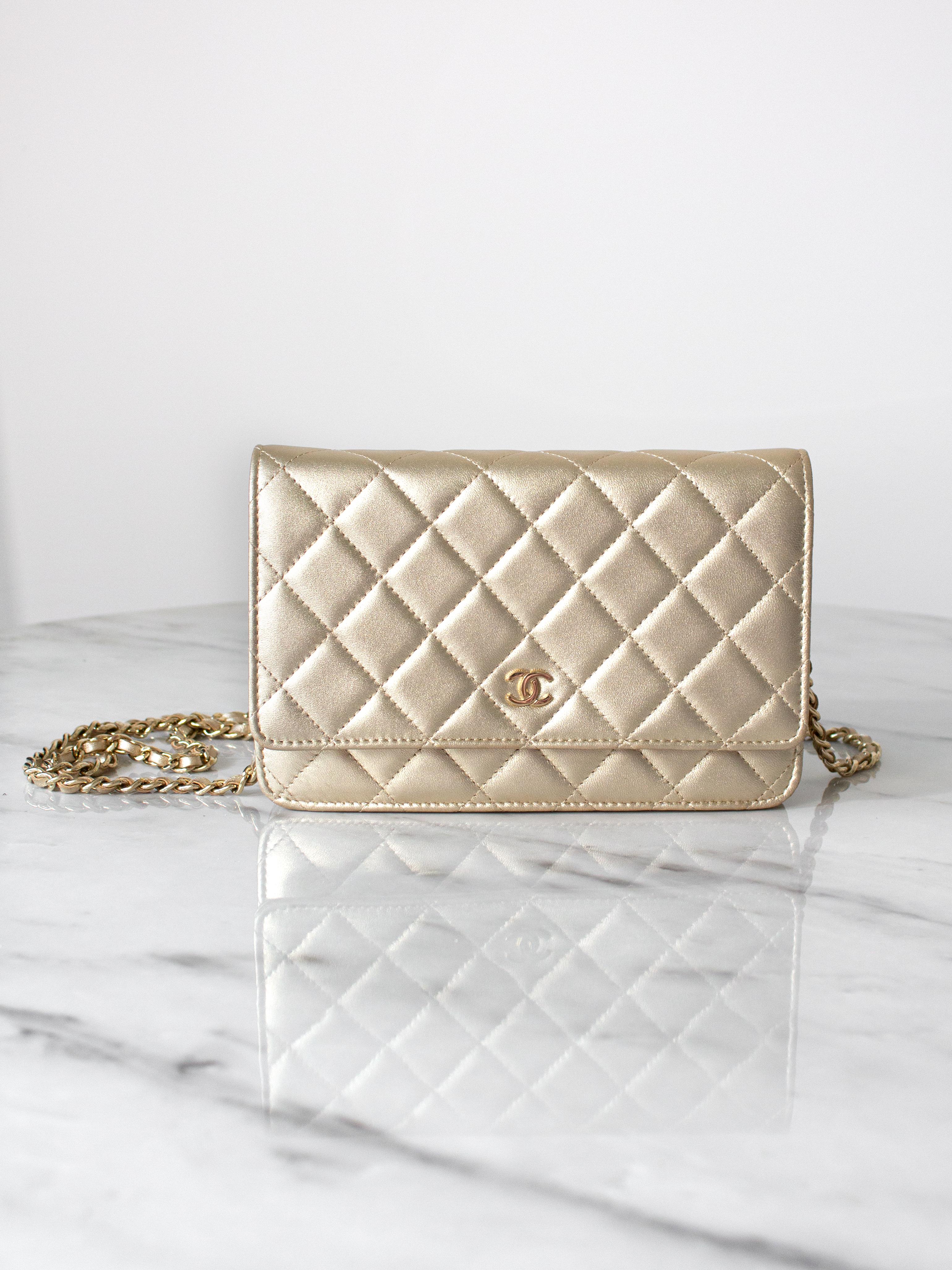 The Chanel classic Wallet on Chain in champagne gold lambskin leather with gold tone hardware. Its iconic quilting, adorned with a CC charm on the front flap and a discreet snap closure. The versatile design includes a half-moon rear pocket and an