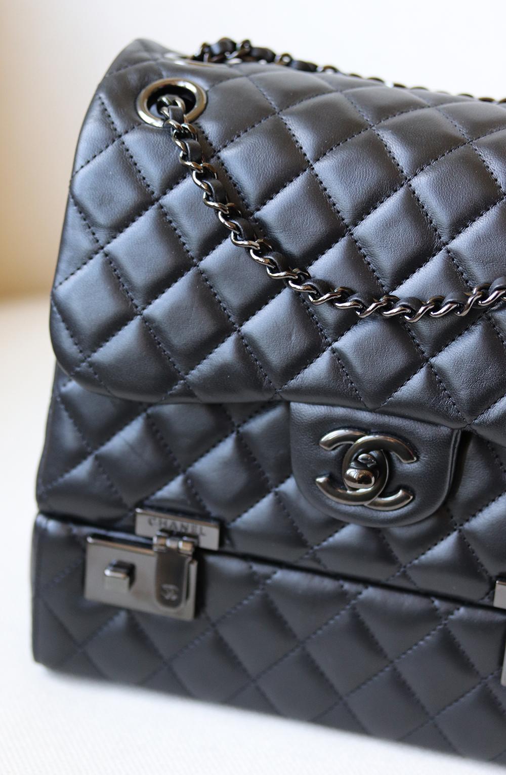 Chanel Classic Quilted Lambskin Luggage Box Flap Bag has been hand-finished by skilled artisans in the label's workshop.
Boasting soft black quilted lambskin-leather exterior, this design is accented with black-toned and black lambskin-leather chain