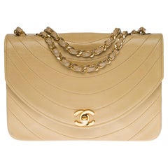 Chanel Classic shoulder bag in beige quilted lambskin and gold hardware
