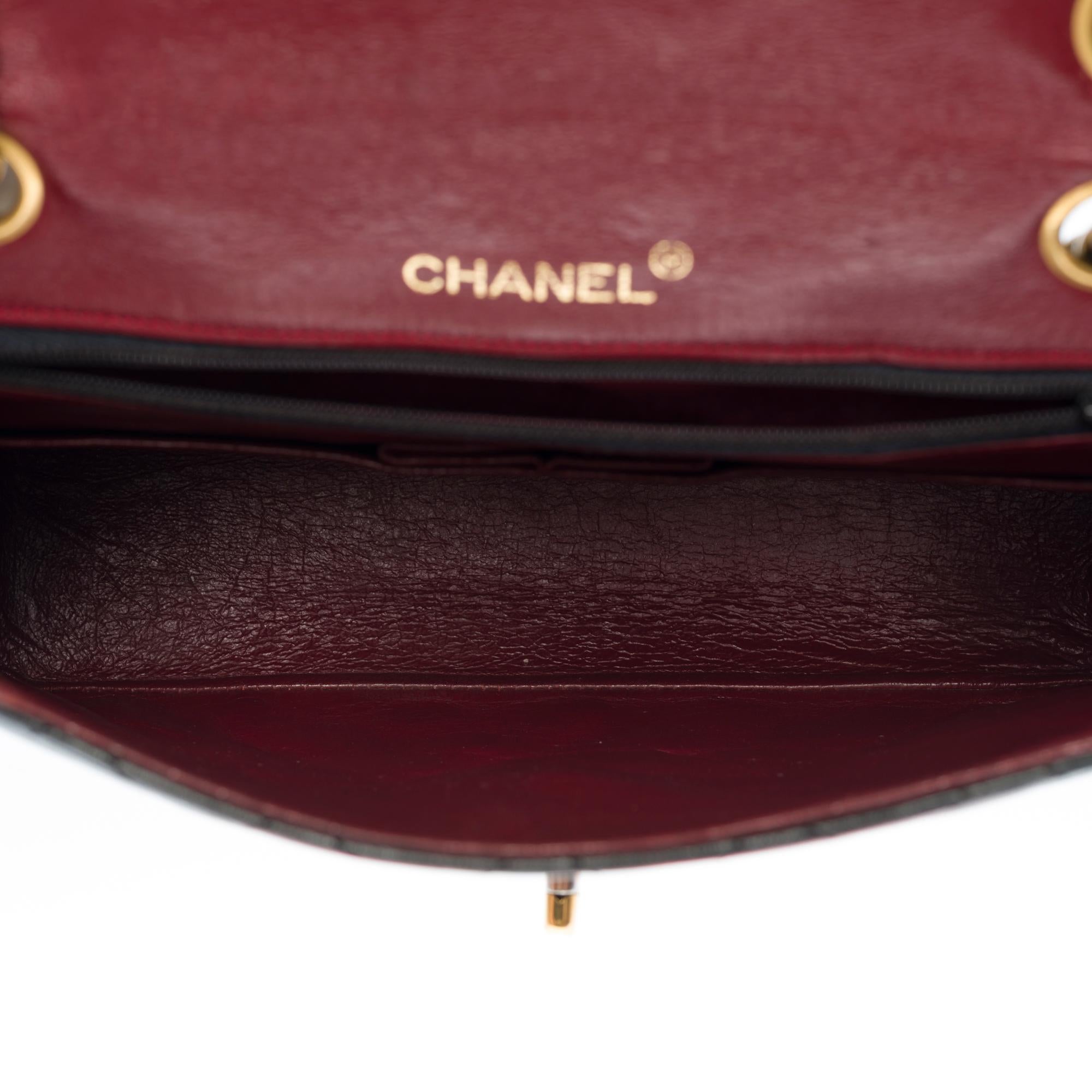 Women's Chanel Classic shoulder Flap bag in black quilted lambskin and gold hardware