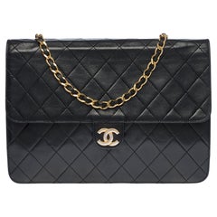 Chanel Classic shoulder Flap bag in black quilted lambskin and gold hardware