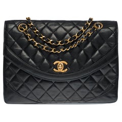 Chanel Classic shoulder Flap bag in black quilted lambskin and gold hardware