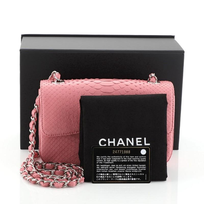 This Chanel Classic Single Flap Bag Python Mini, crafted from genuine pink python skin, features woven-in leather chain strap, exterior back pocket and silver-tone hardware. Its CC turn lock closure opens to a pink leather interior with zip and slip