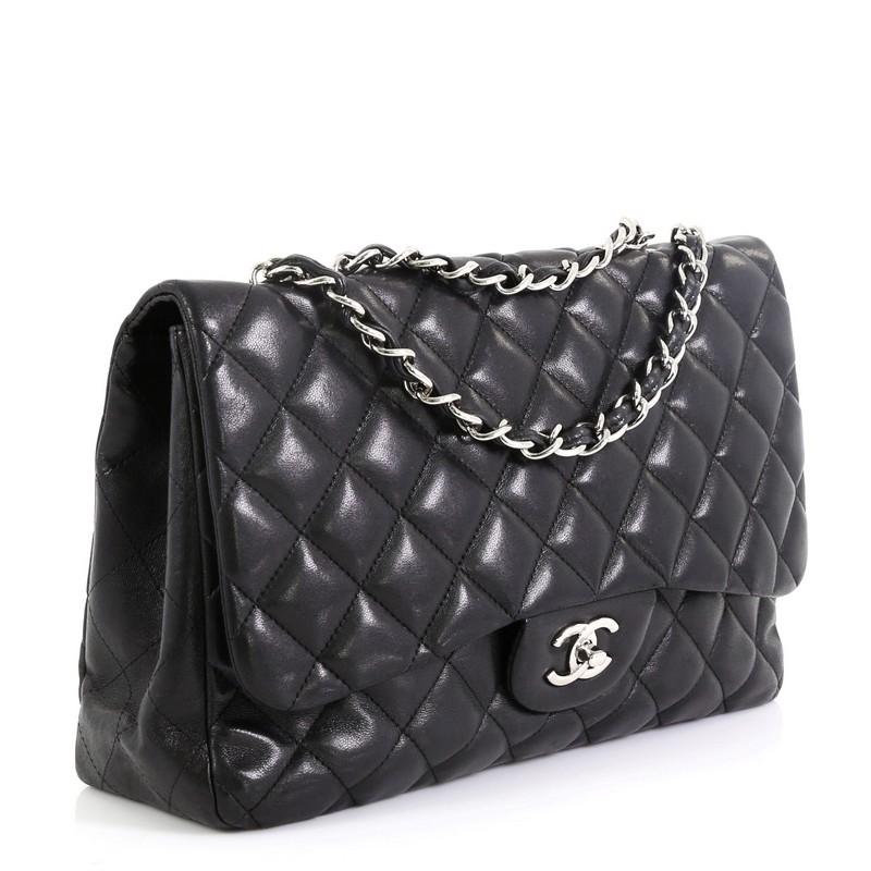 This Chanel Classic Single Flap Bag Quilted Lambskin Jumbo, crafted in black quilted lambskin leather, features woven-in leather chain strap, exterior back pocket, CC signature turn-lock closure and silver-tone hardware. Its turn-lock closure opens
