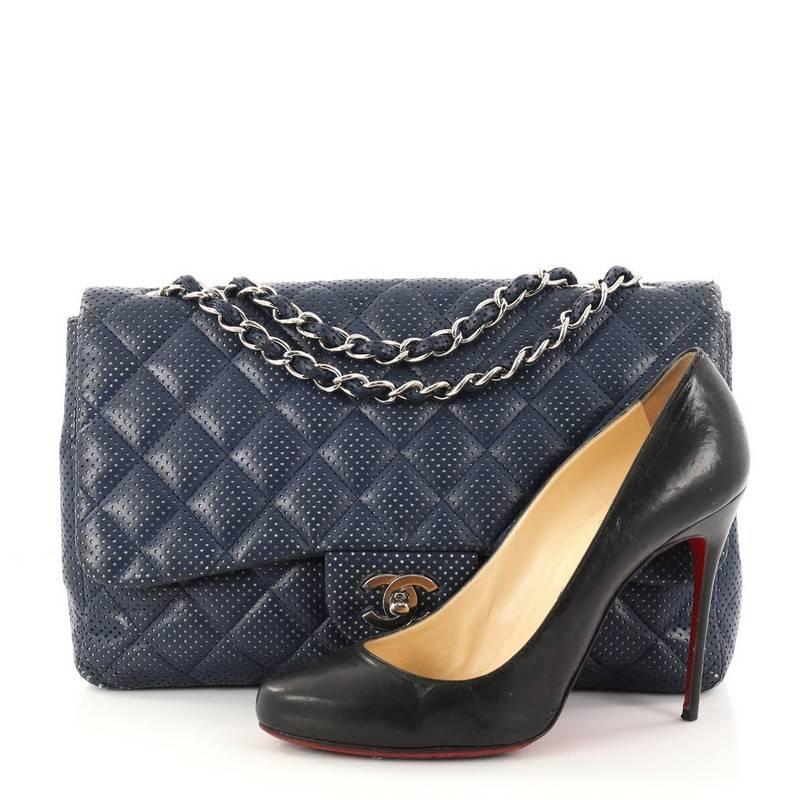 This authentic Chanel Classic Single Flap Bag Quilted Perforated Leather Jumbo is timeless and chic embodying Chanel's classic design. Crafted from blue quilted perforated leather, this oversized eye-catching flap bag features a structured