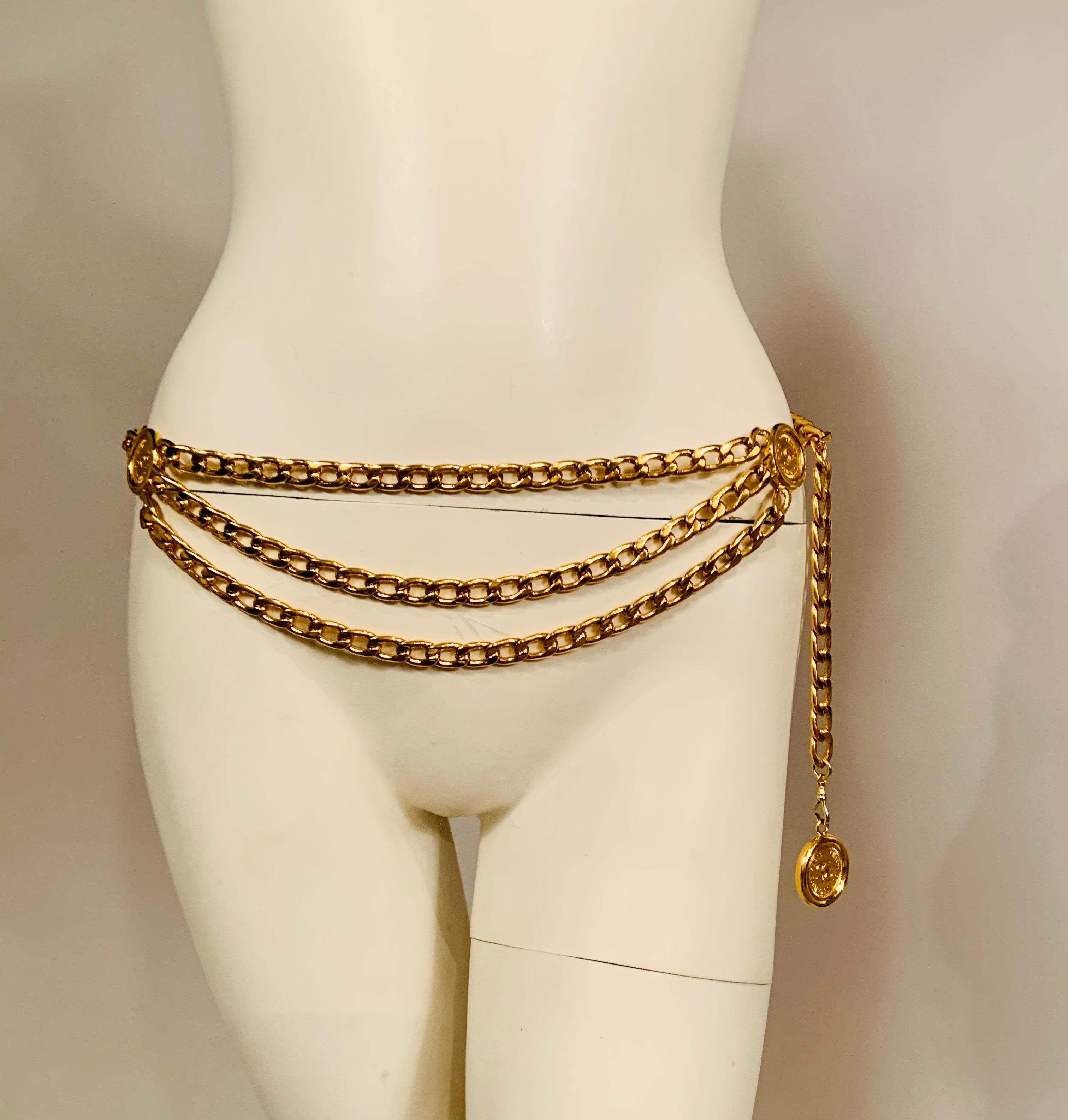 This classic three row Chanel gold toned chain belt has three large round medallions with the famous Paris address of her Chanel House, 31 rue Cambon on both sides.  The hook used to adjust the size is stamped Chanel with the double C logo. The belt