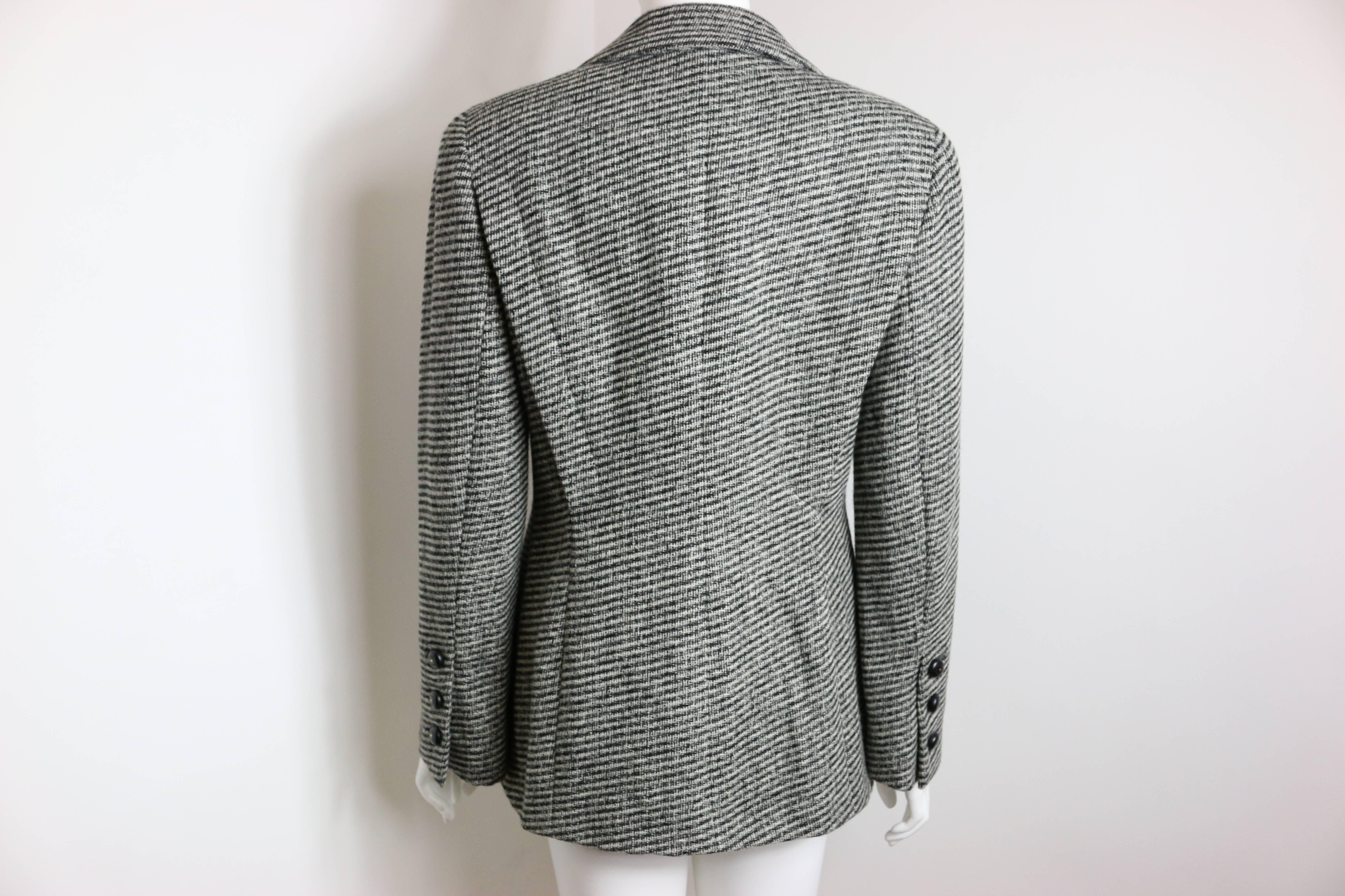 - Vintage Chanel classic black and white tweed from fall 1994 collection 

- 100% wool and silk lining .

-  Single breasted blazer with two front pockets. 

-  One front button and three buttons on each cuff. 

- Made in Italy. 

- Size 38

