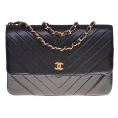 Chanel Classique bag in black herringbone quilted leather with gold hardware