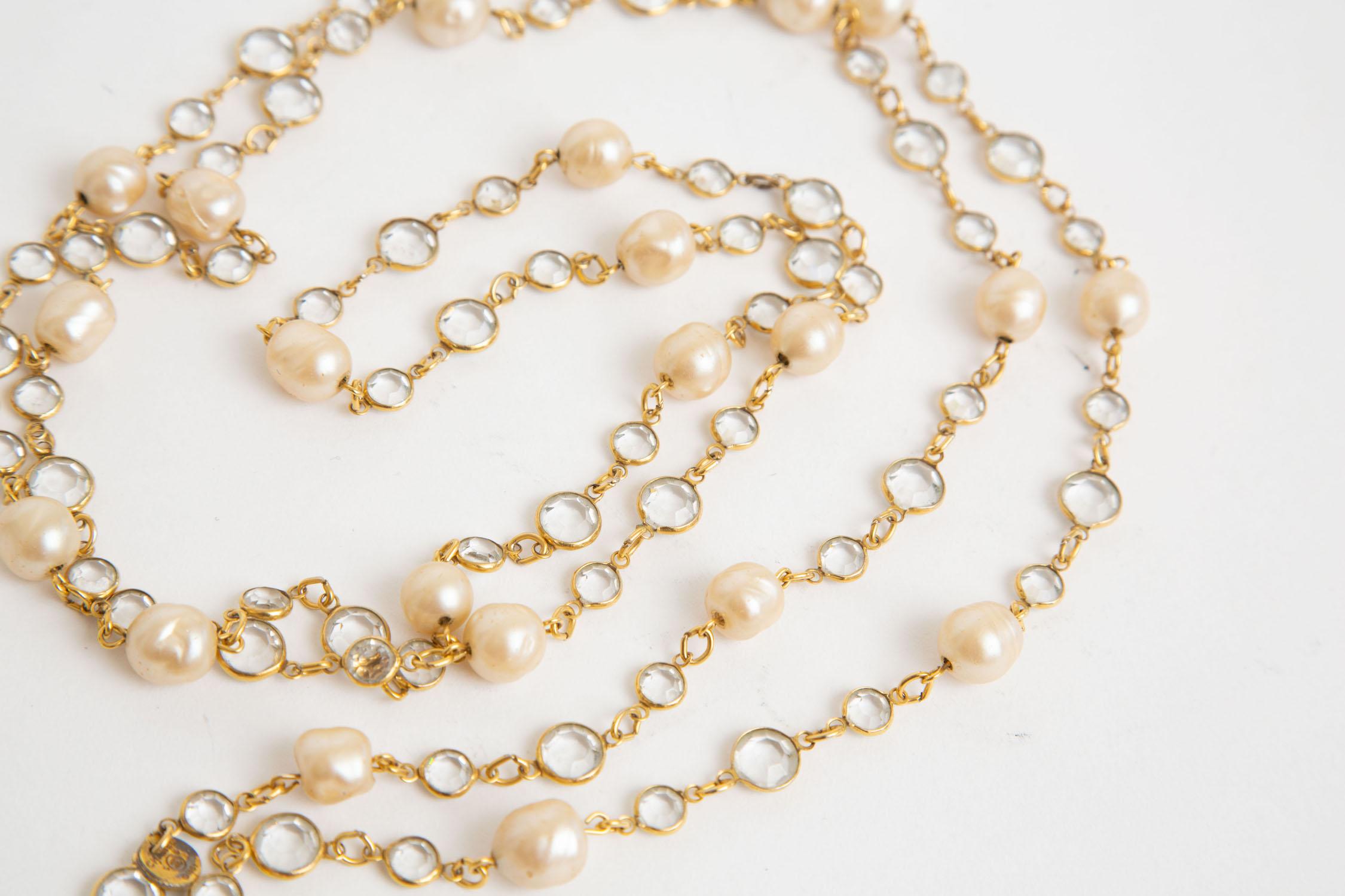 This vintage beveled crystals and faux pearl Chanel long chain and link sautoir necklace is 62 inches long and can wrap many times around as staggered lengths or even closer to your neck. The Chanel hangtag says 1981. The beveled crystals are clear