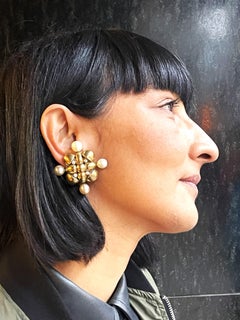 Chanel clip-on earrin shape of a cross sign. 1970-1981, gold plated, faux pearls