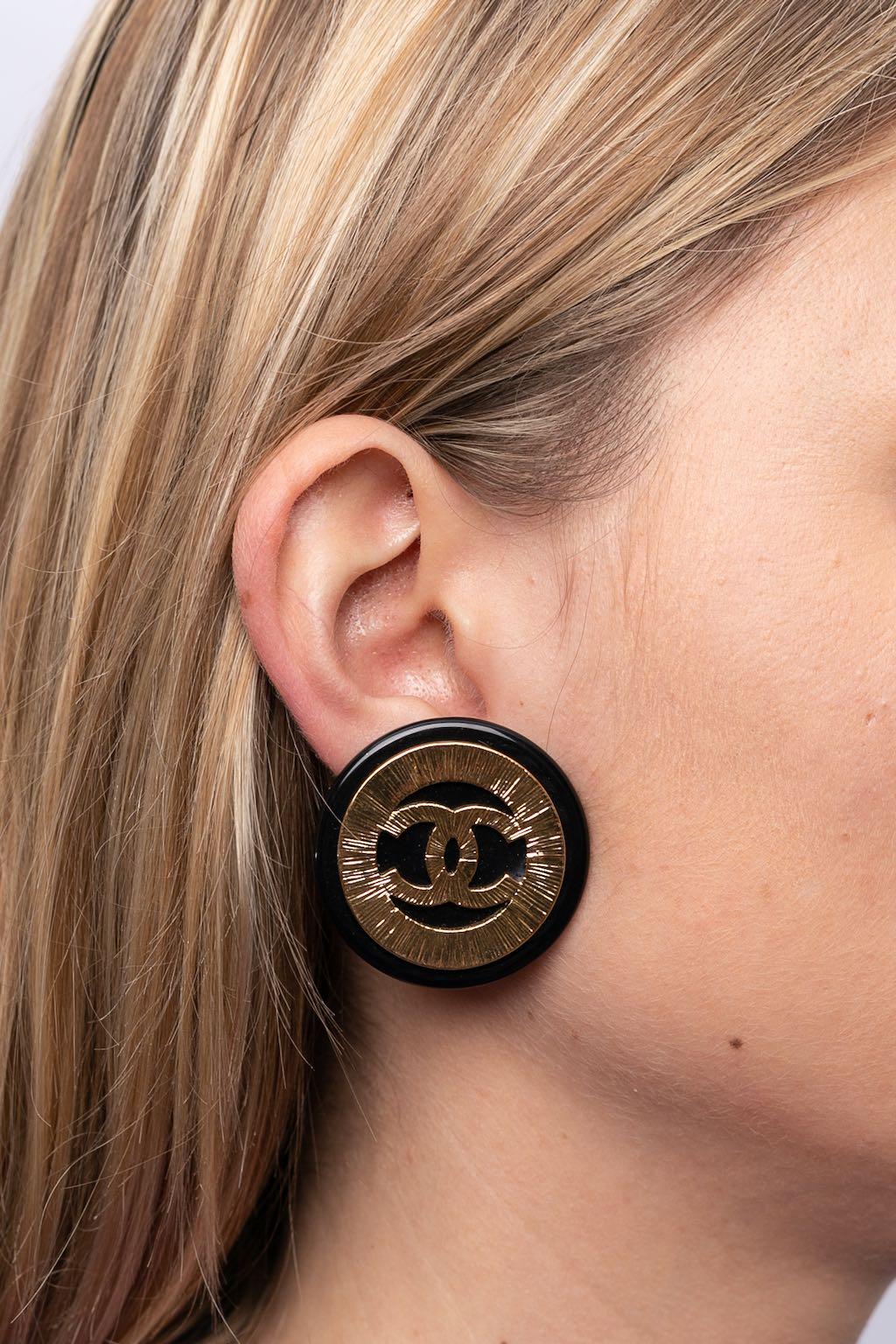 Chanel (Made in France) Clip-on earrings made of gilted metal and bakelite. Spring-Summer 1994 collection.

Additional information:

Dimensions: 
Ø 4 cm (Ø 1.57