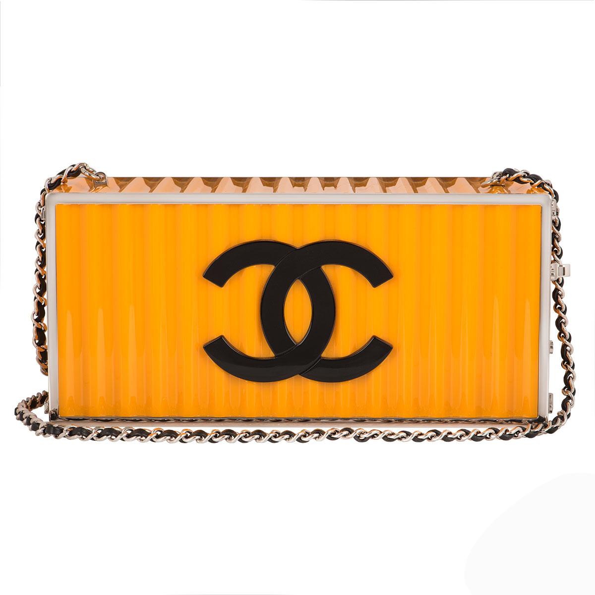 A stunning Chanel clutch bag from the Metiers D'arts Paris-Hamburg collection. Part of the summer 2018 collection the bag is made from resin decorated with silver hardware in a design of a yellow shipping container with the Chanel logo on one side,