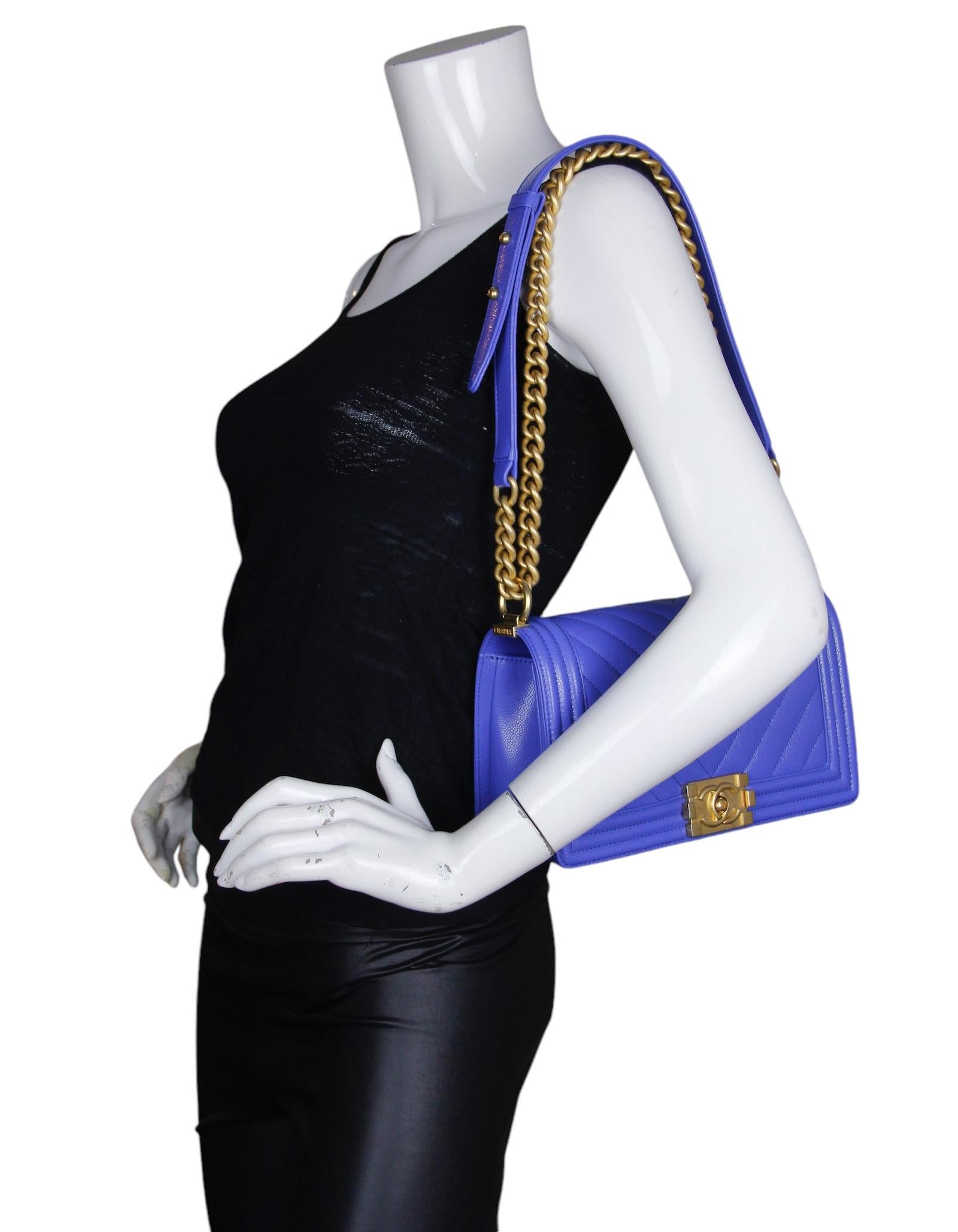 Chanel Cobalt Blue Caviar Leather Chevron Quilted Medium Boy Bag   

Made In: Italy
Color: Cobalt blue
Hardware: Goldtone
Materials: Shiny caviar leather
Lining: Leather
Closure/Opening: Flap top with pushlock
Exterior Pockets: None
Interior