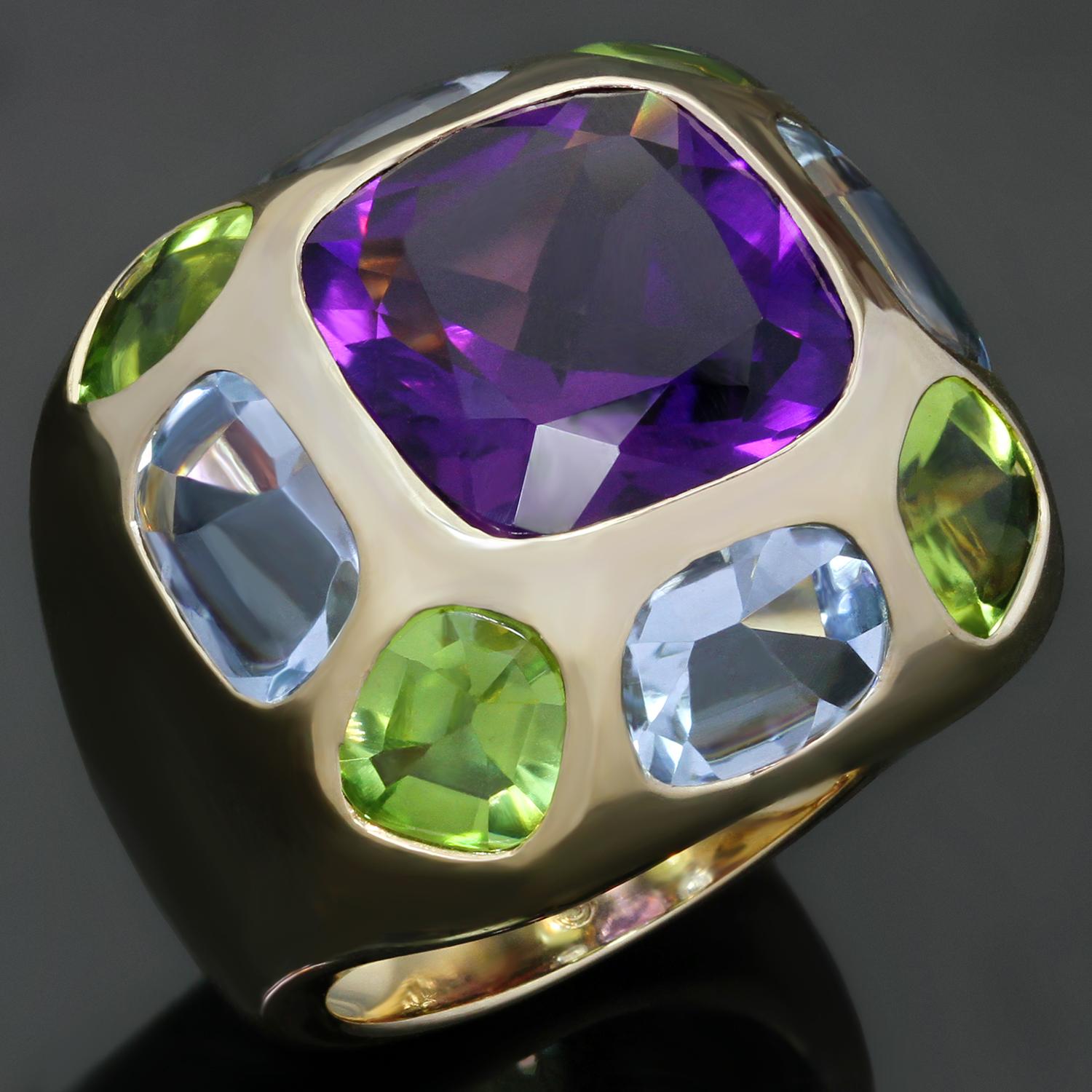 This stunning Chanel cocktail dome band ring from the Coco collection is made in 18k yellow gold and features a faceted amethyst in the center surrounded by 4 cabochon peridots and 4 cabochon oval aquamarines. A chic and vibrant design. Made in