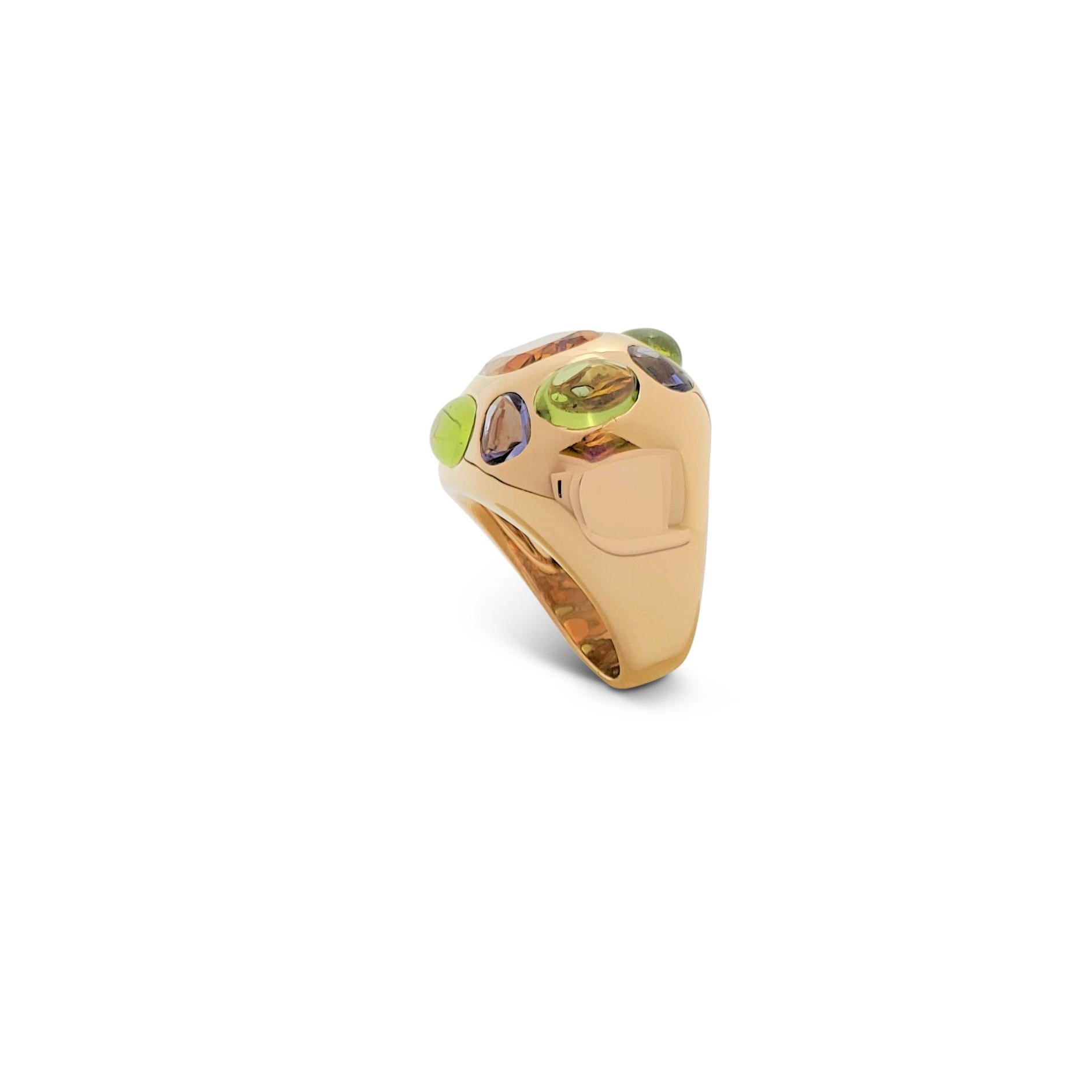 Authentic vibrant Chanel cocktail ring from the 'Coco' collection crafted in 18 karat yellow gold features a faceted citrine in the center weighing an estimated 7 carats which is surrounded by alternating cabochon peridots and oval tanzanites