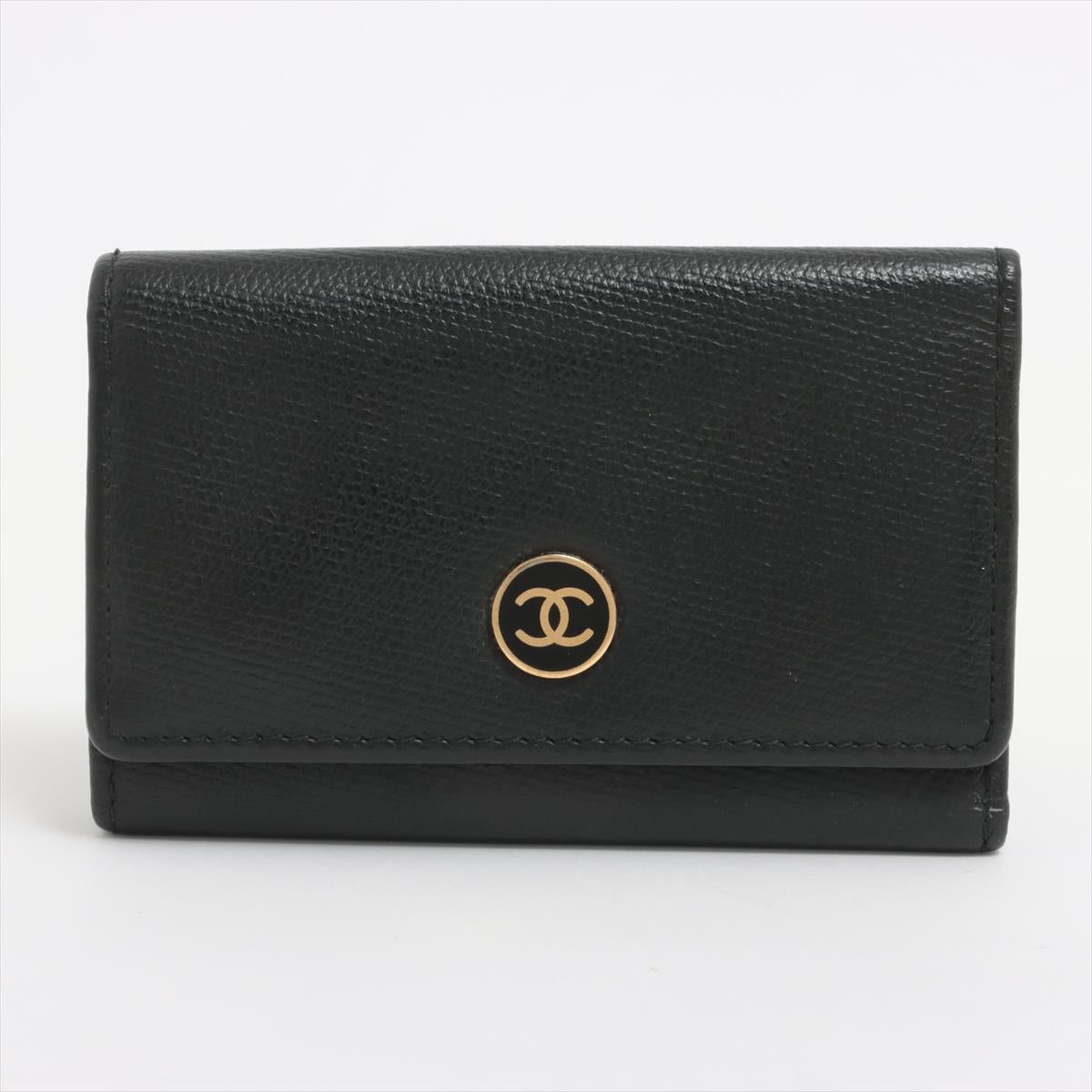 The Chanel Coco Button Leather Key Case in Black is the epitome of elegance and functionality. Crafted from luxurious leather, it exudes sophistication and durability, embodying Chanel's timeless style. The sleek black hue adds a touch of