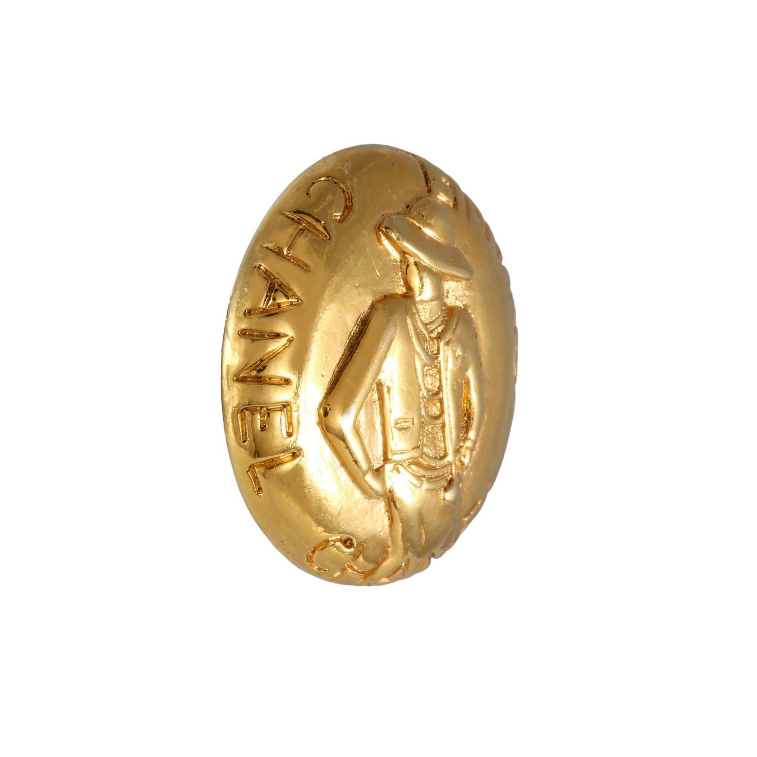 This authentic Chanel Gold Coco Button Pin is in very good vintage condition from the 1970’s.  Simple gold tone round button is engraved with CHANEL lettering and Coco’s silhouette.  Made in France.  Pouch or box included.
